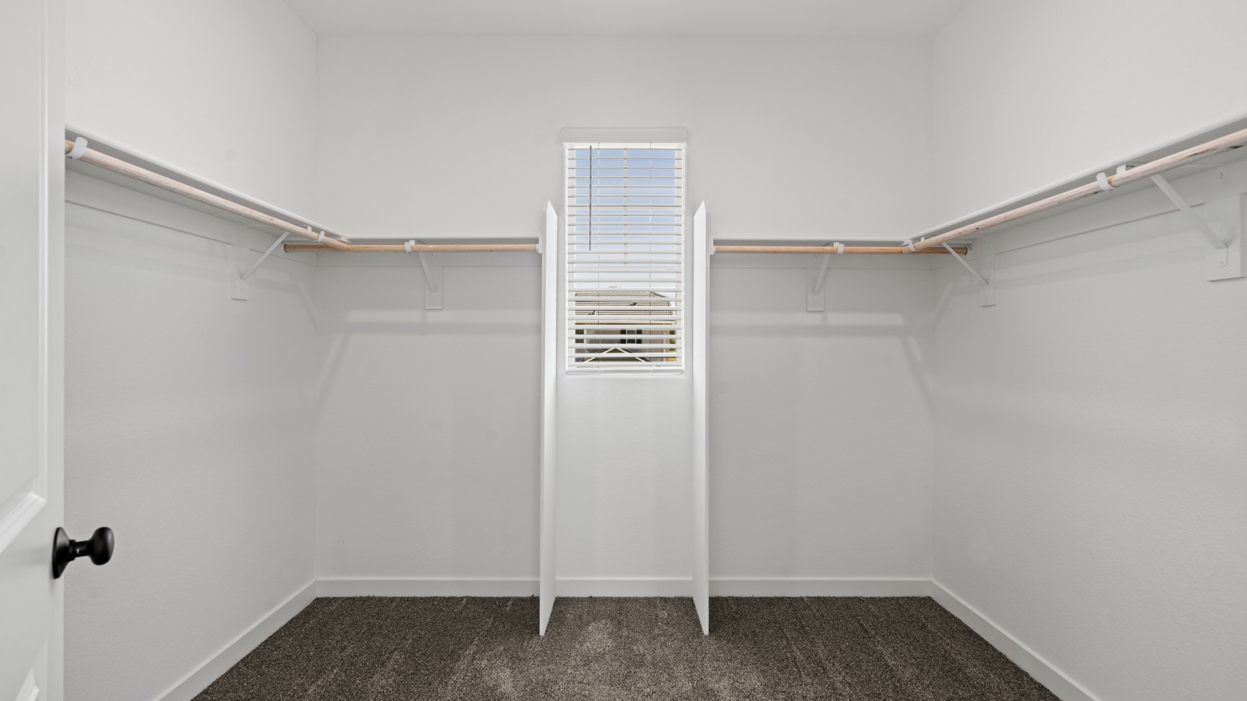 A white door with a metal bar.