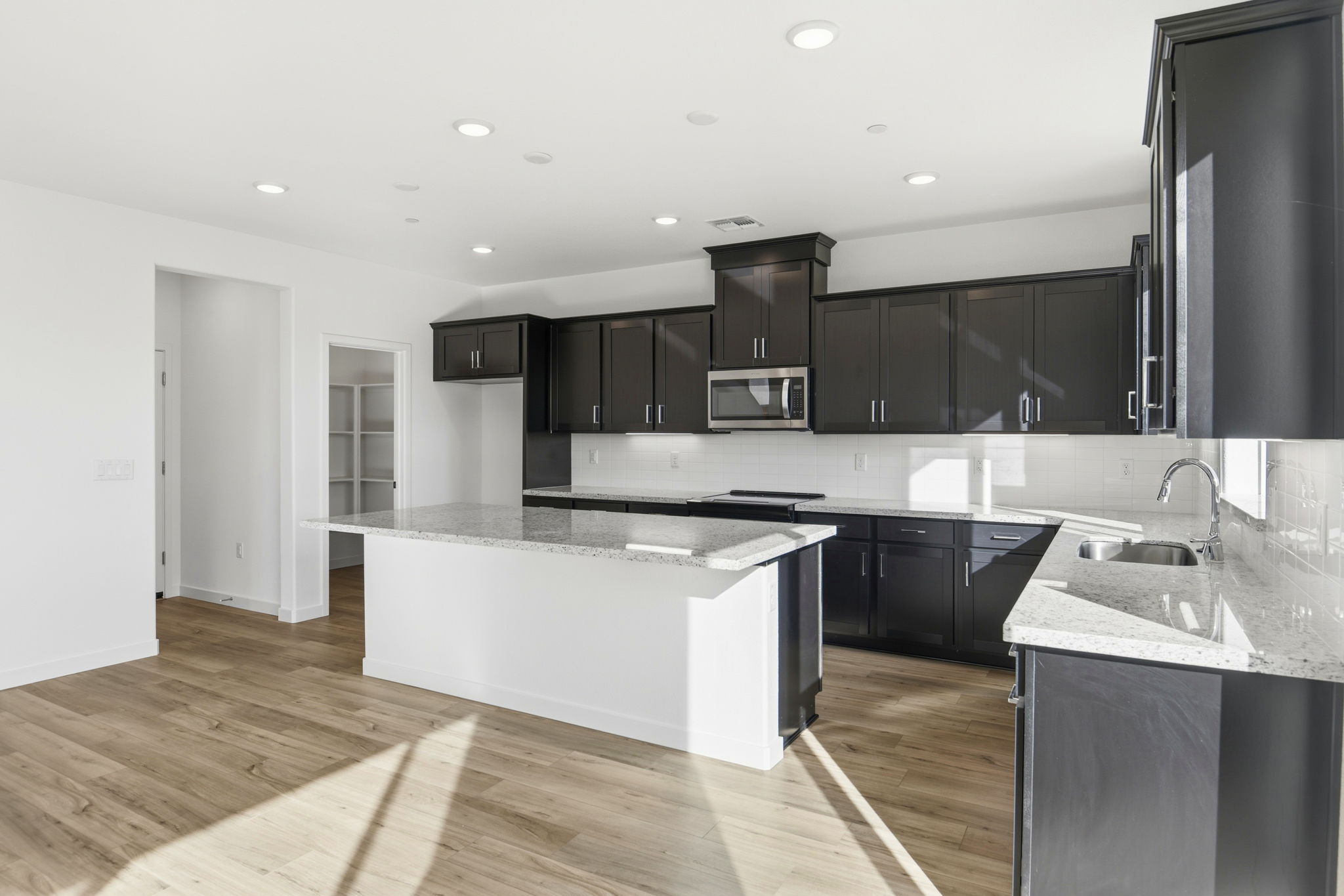 A kitchen with black cabinets.