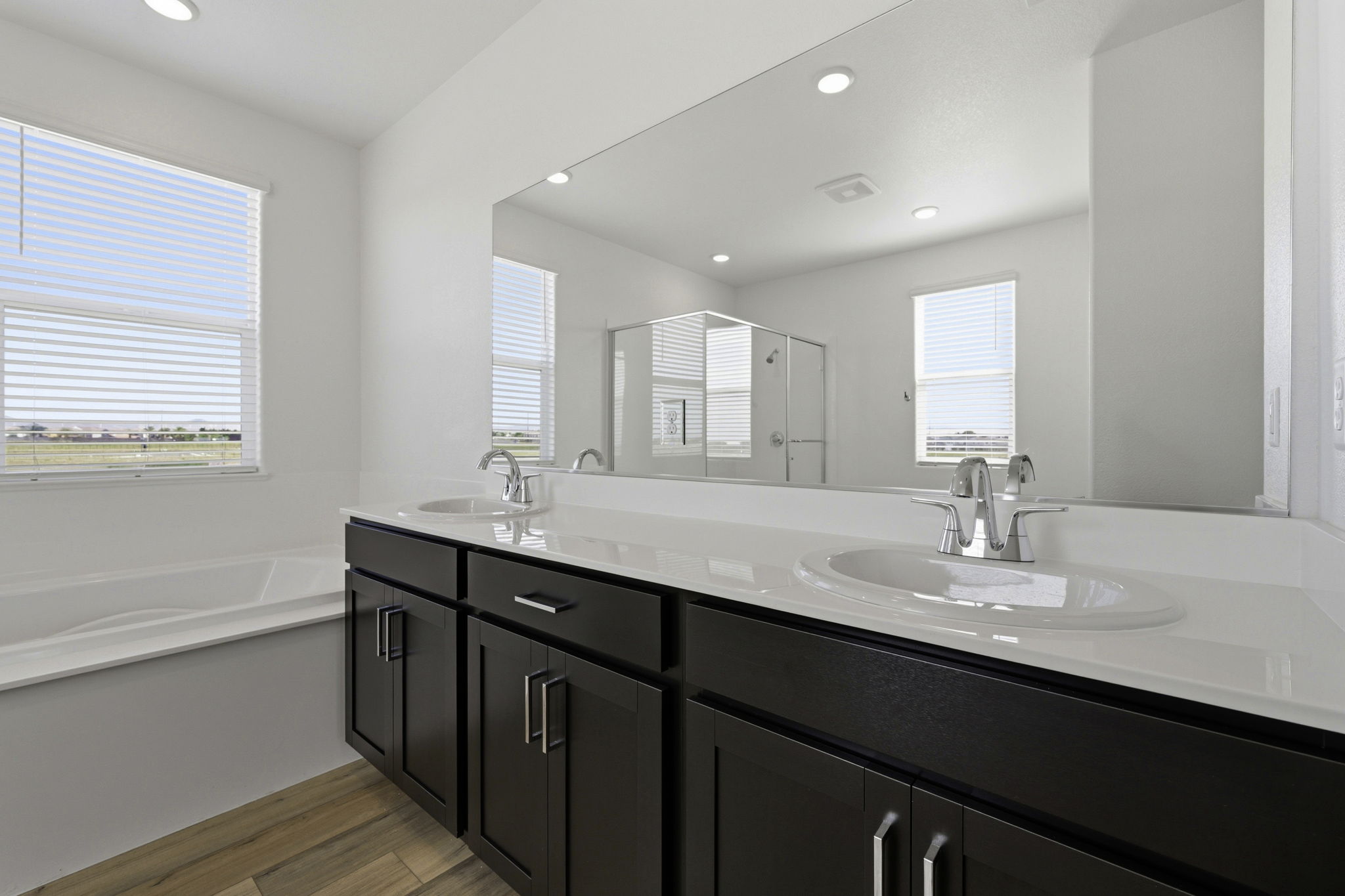 A bathroom with a large mirror.