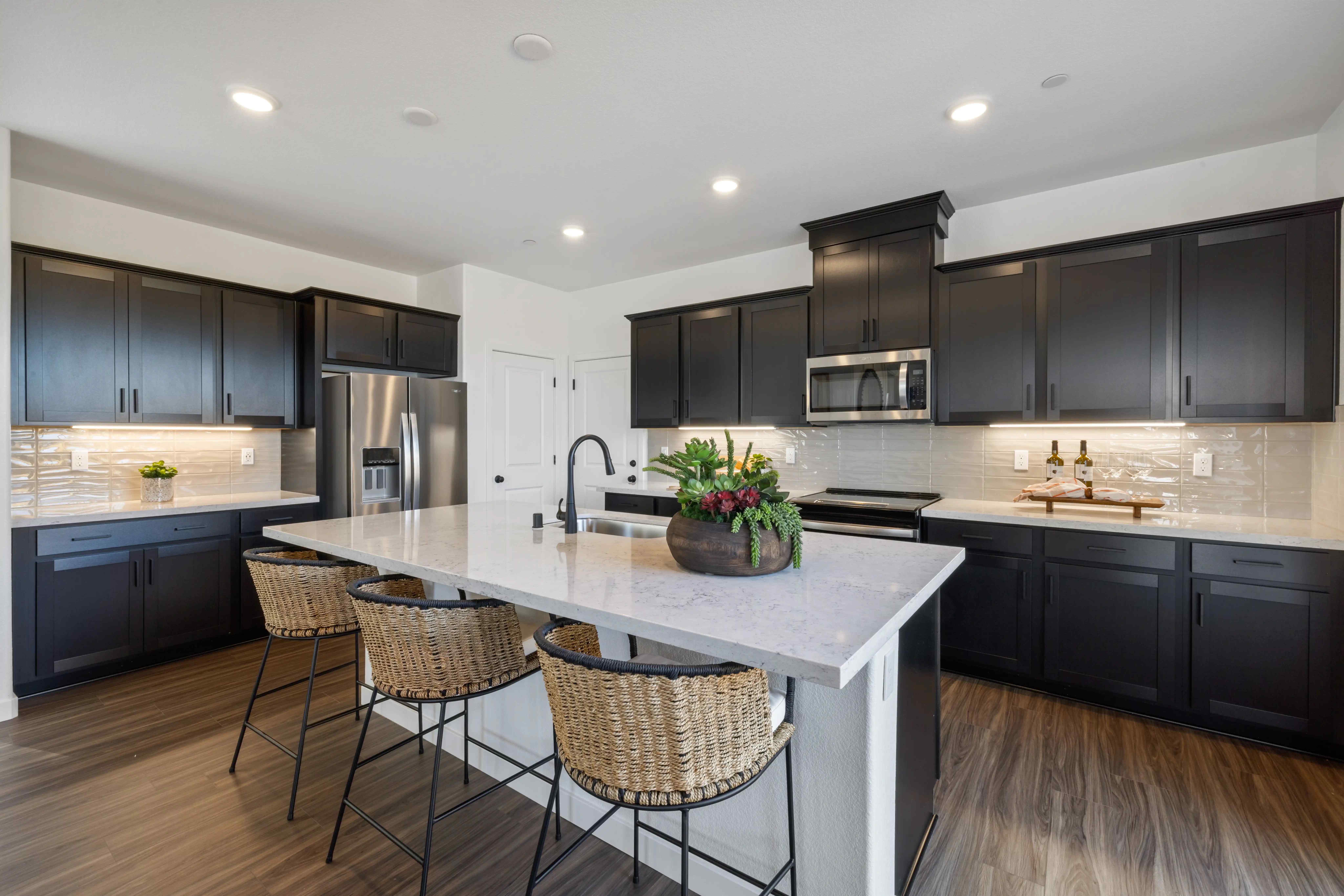 A kitchen with black cabinets.