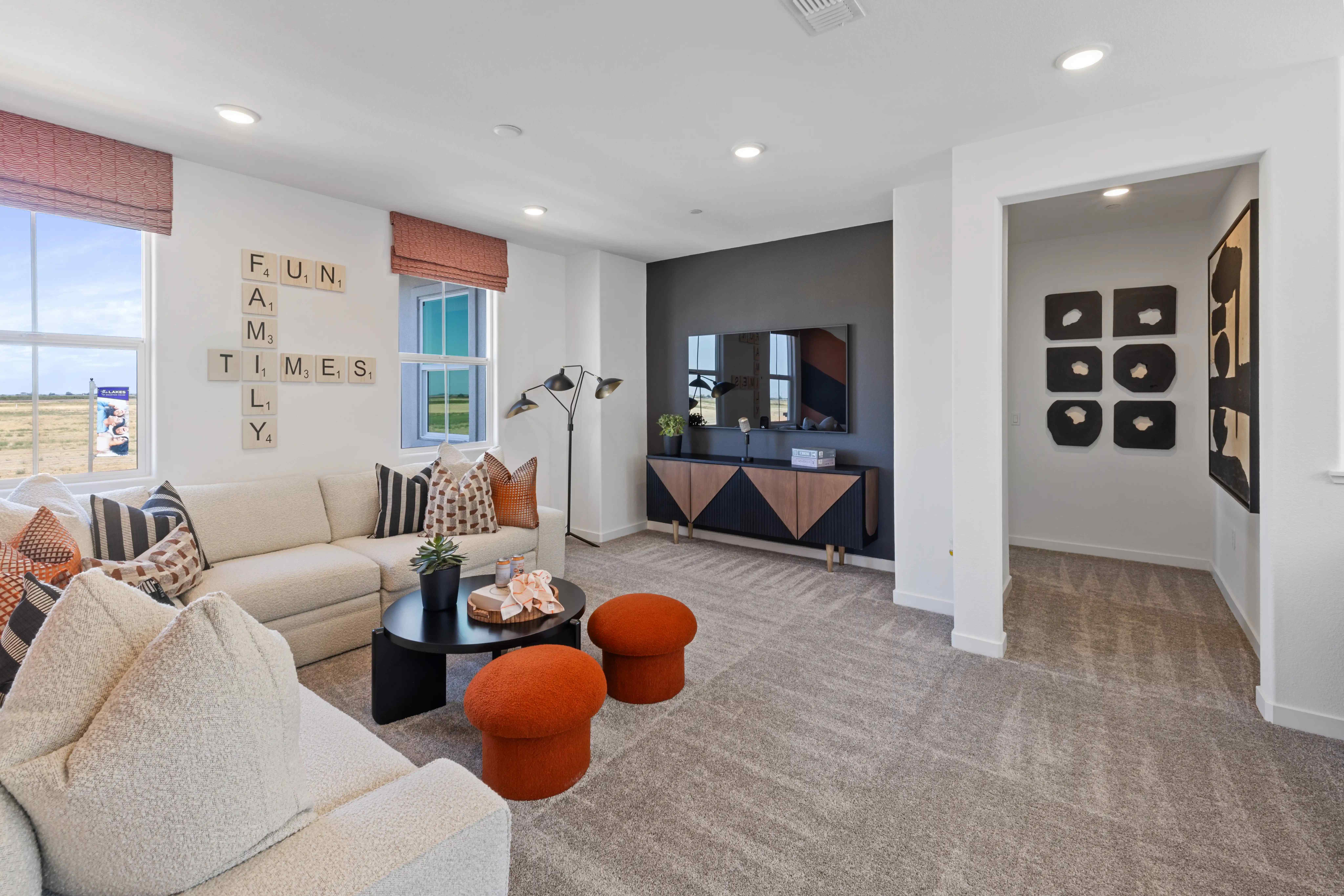 A living room with a large tv and couches.