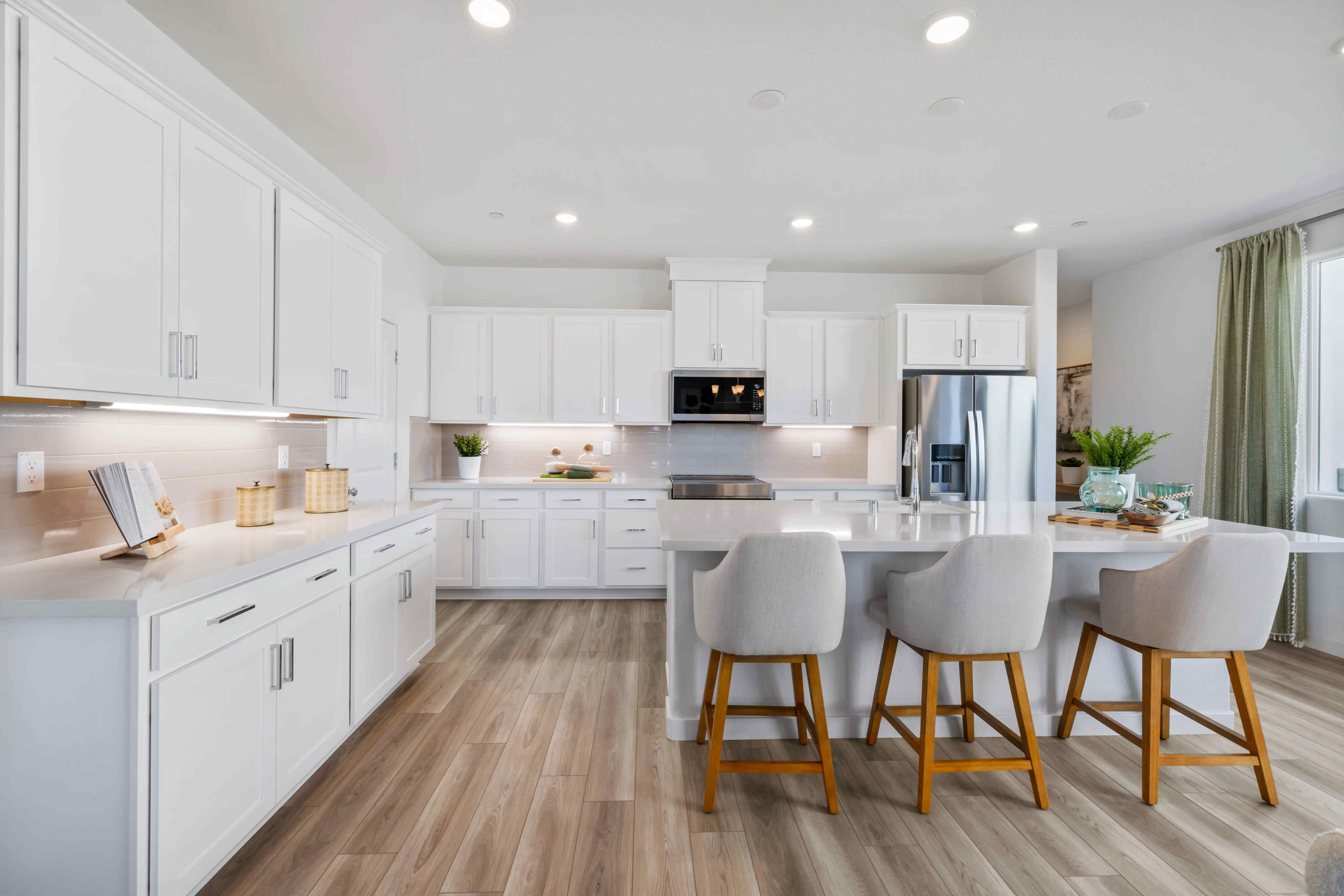 A kitchen with white cabinets.