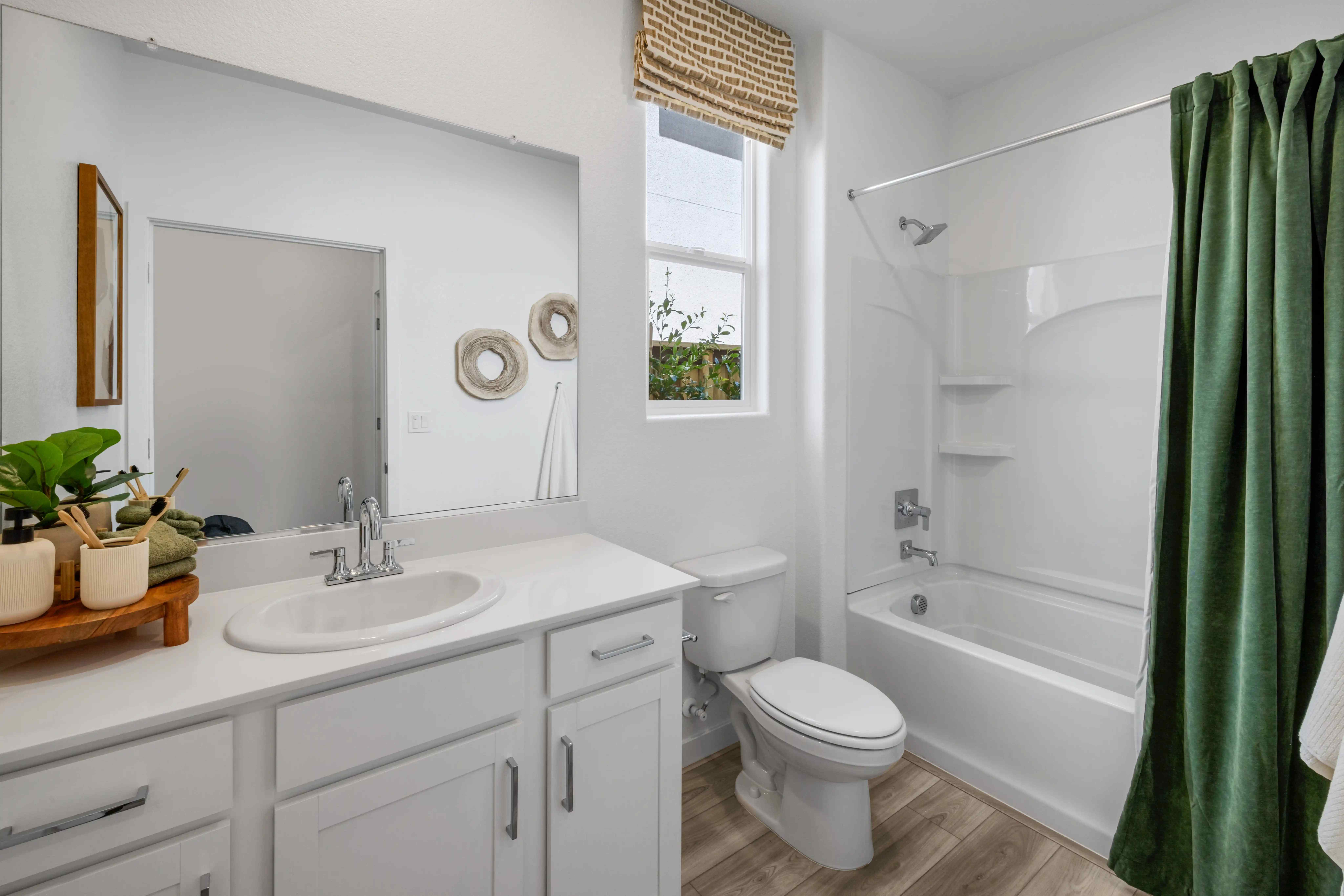 A bathroom with a tub sink and toilet.