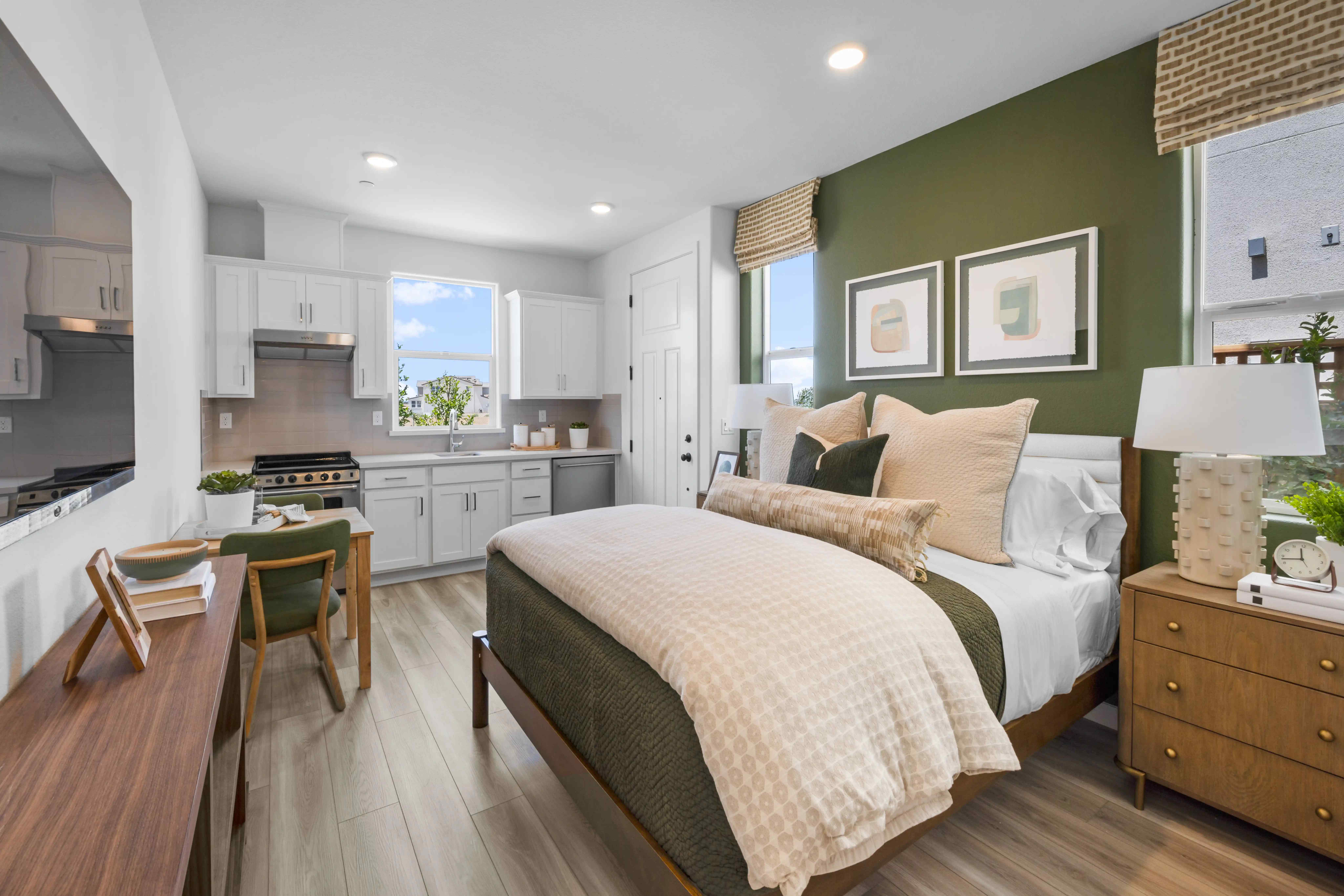 A bedroom with a bed and a table.
