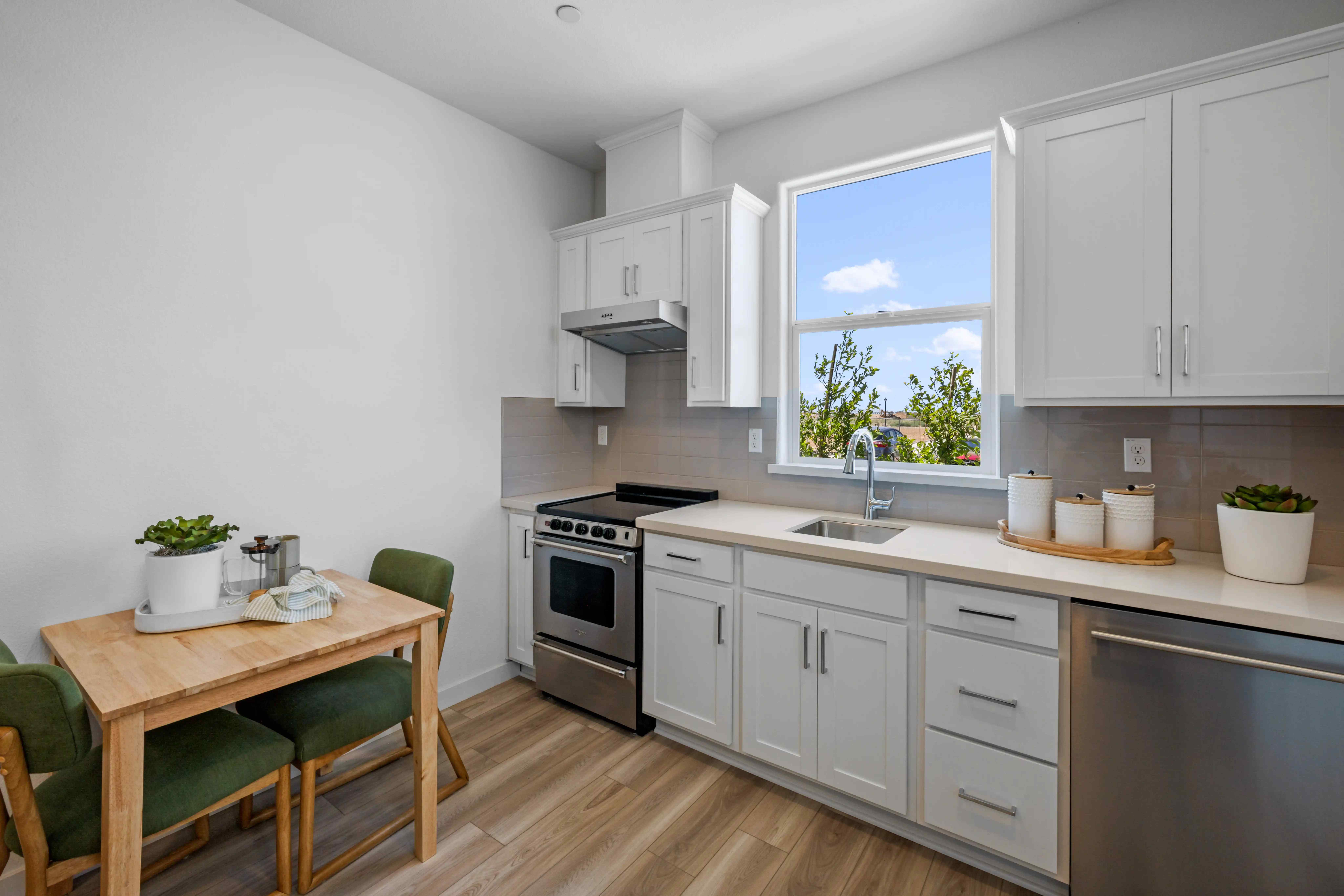 A kitchen with white cabinets.