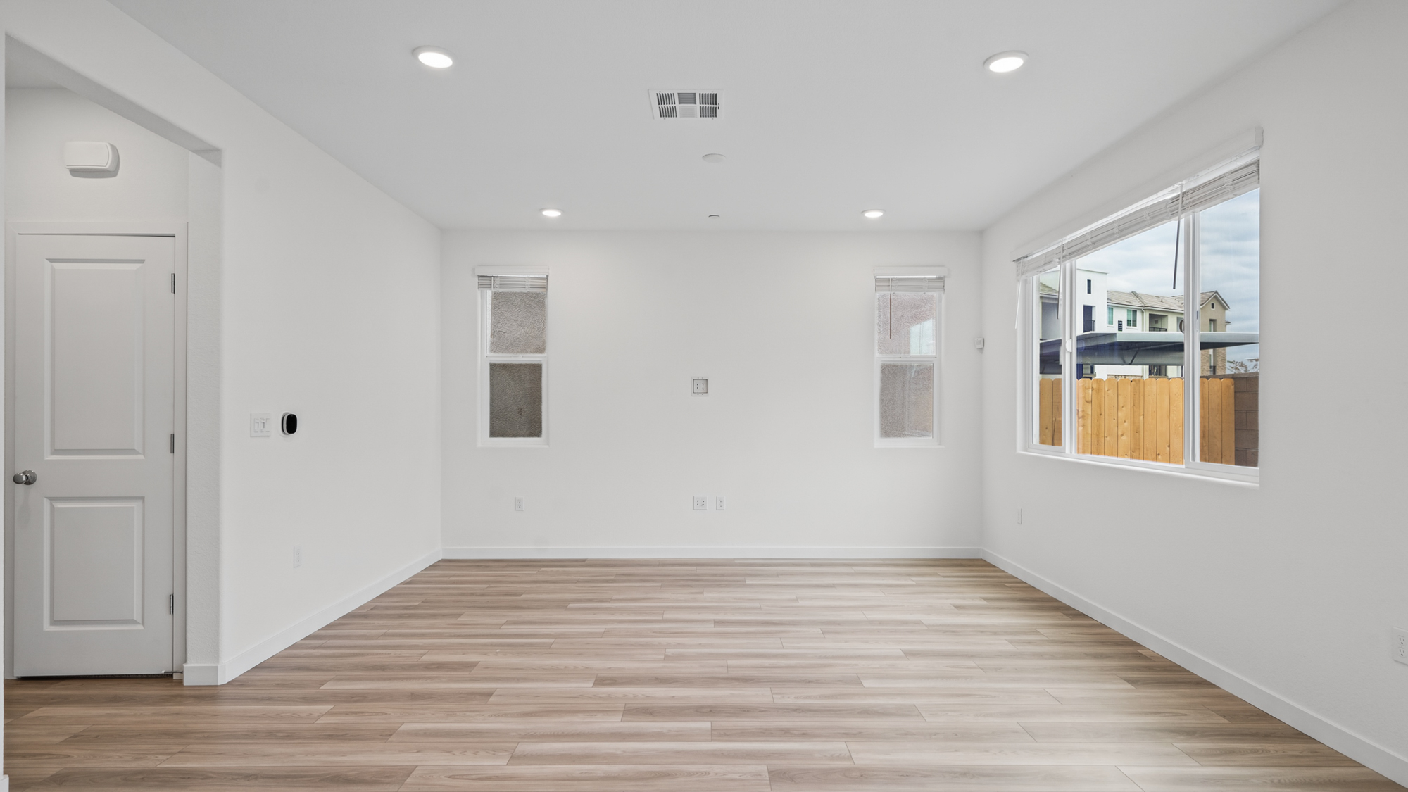 A room with white walls and a wood floor.