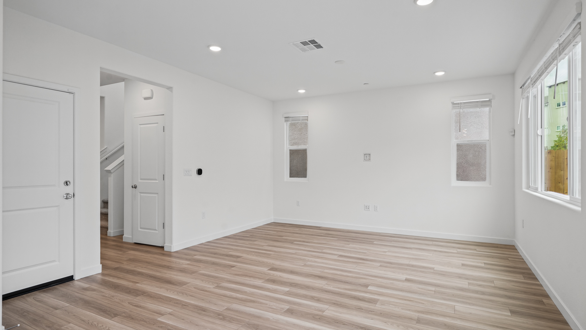 A room with white walls and wood floors.