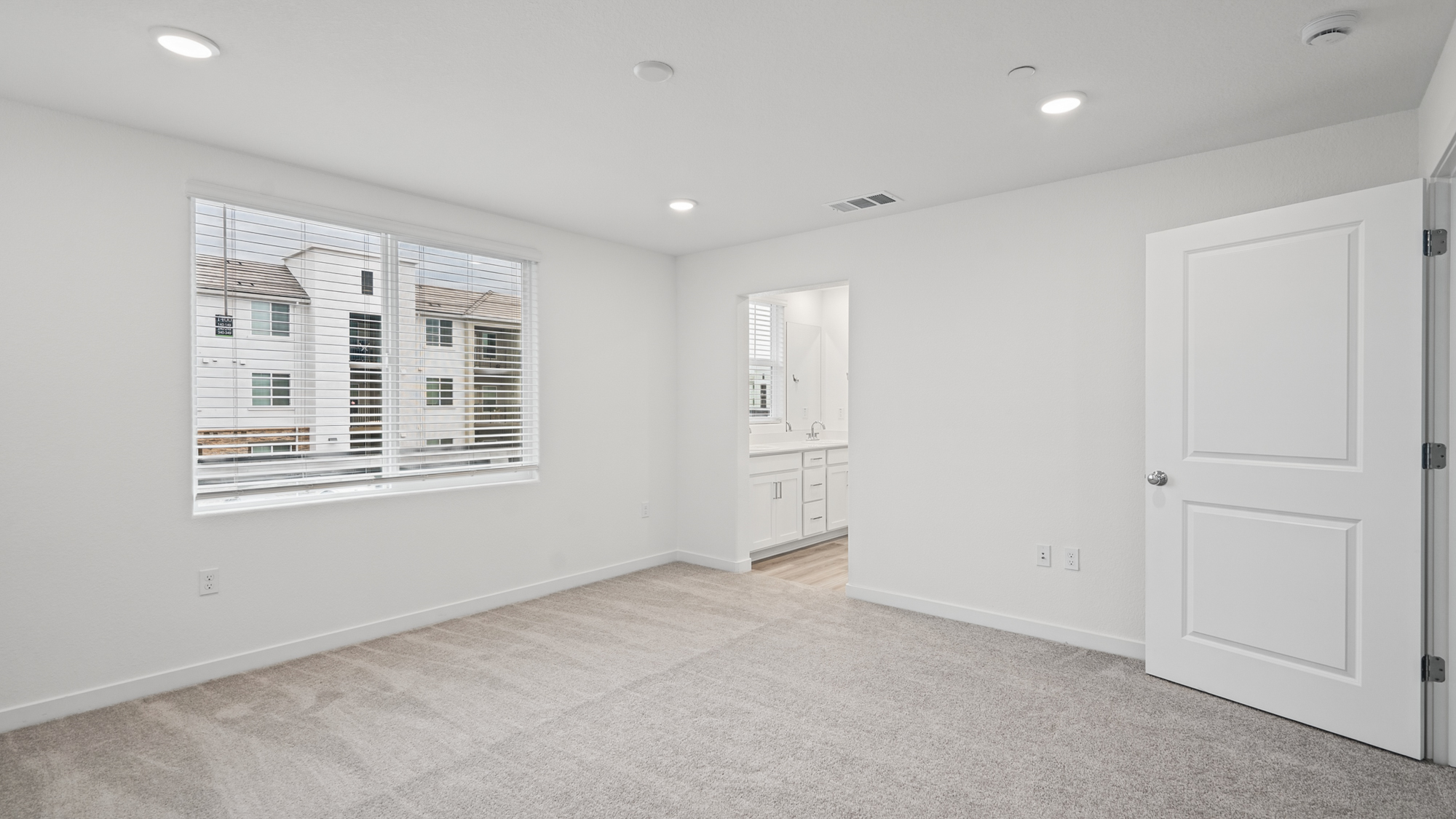 A room with white walls and a window.