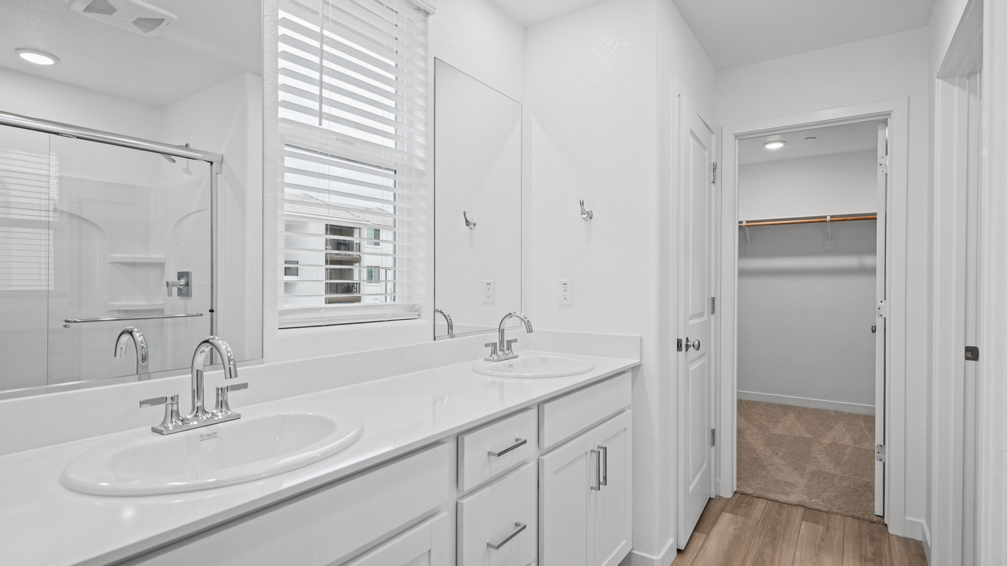 A bathroom with white cabinets.