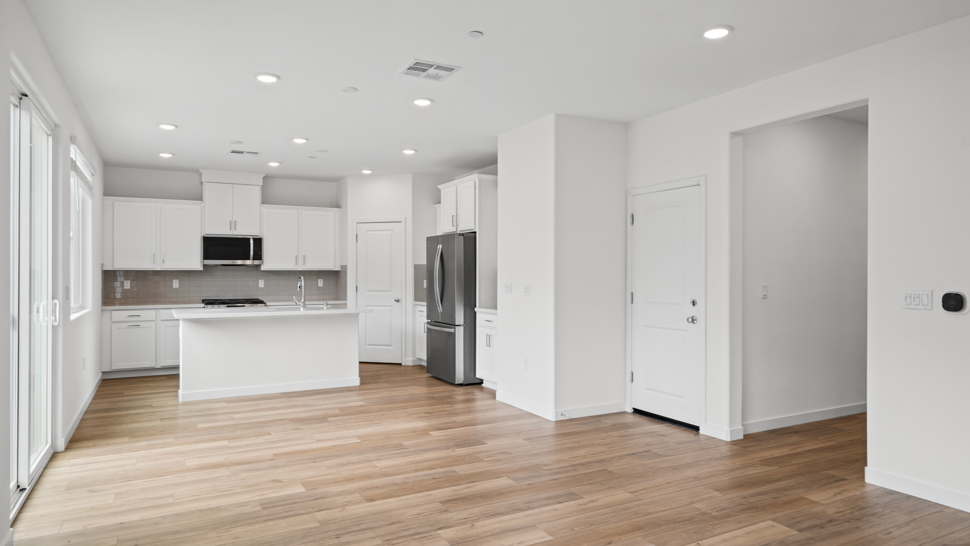 A kitchen with white cabinets.