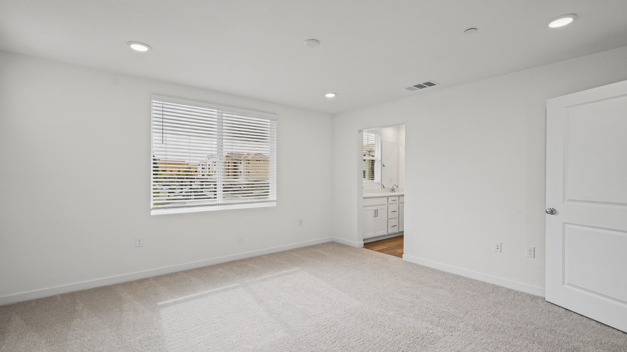 A room with white walls and a window.