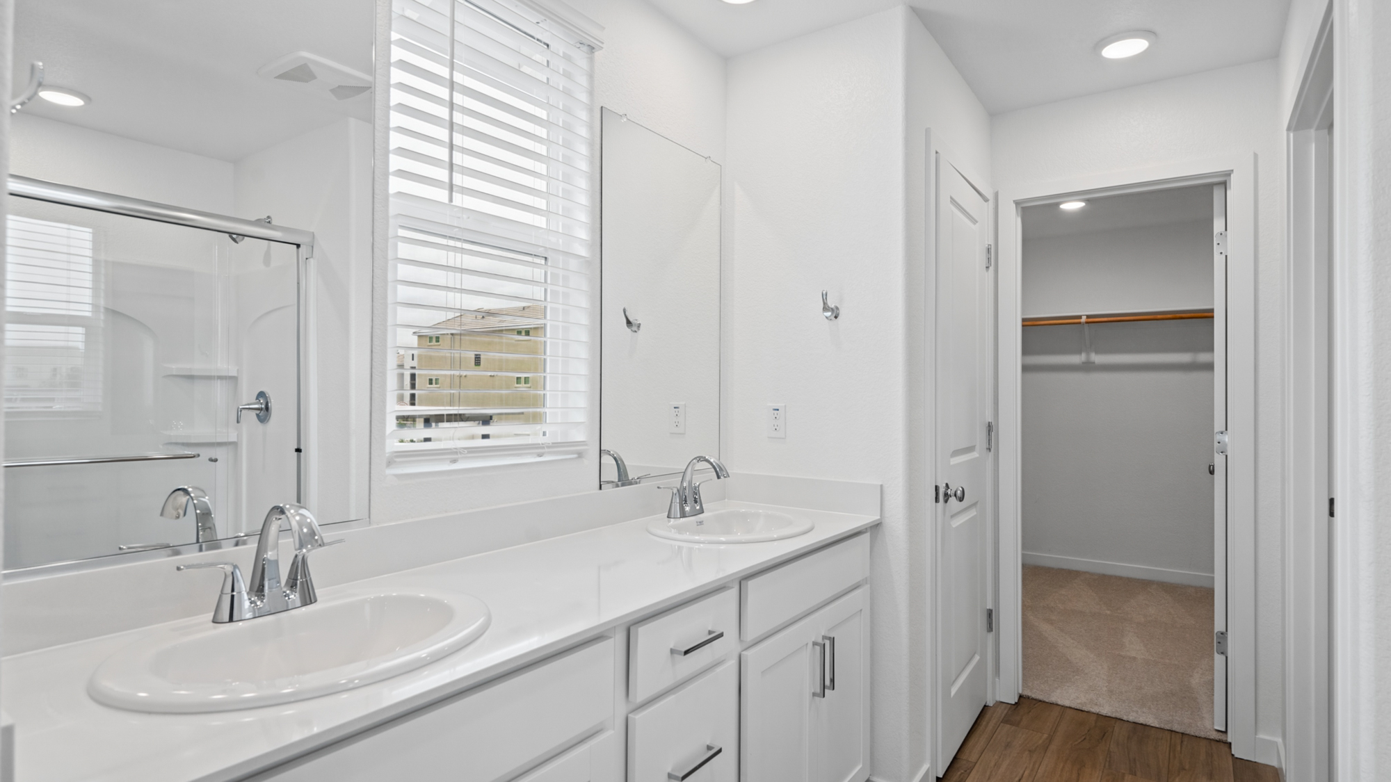 A bathroom with white cabinets.