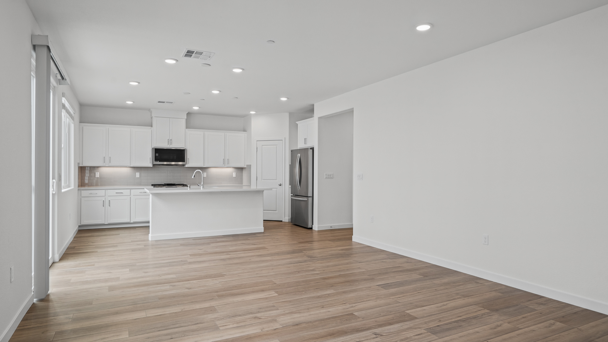 A kitchen with white cabinets.