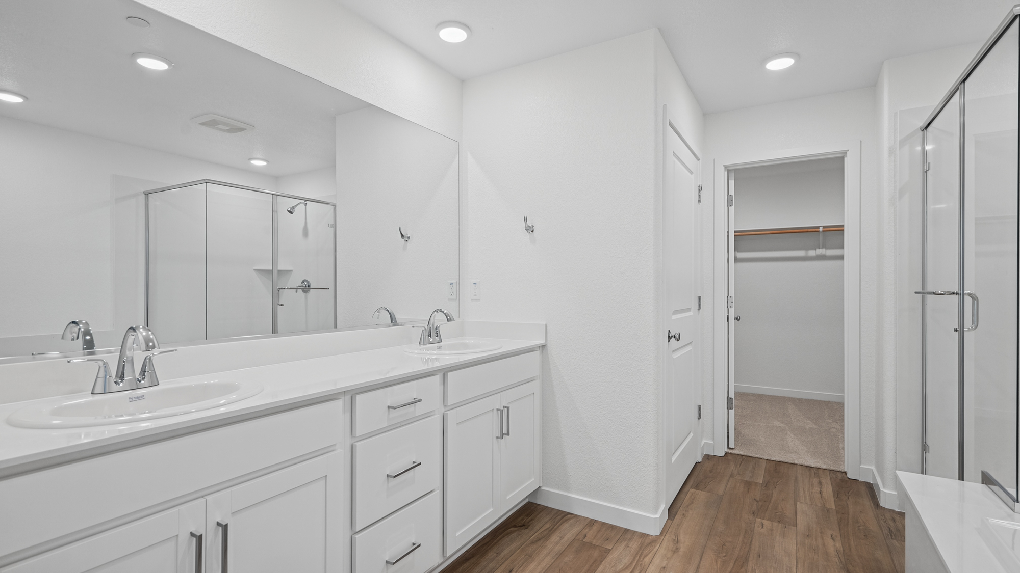 A bathroom with white cabinets.