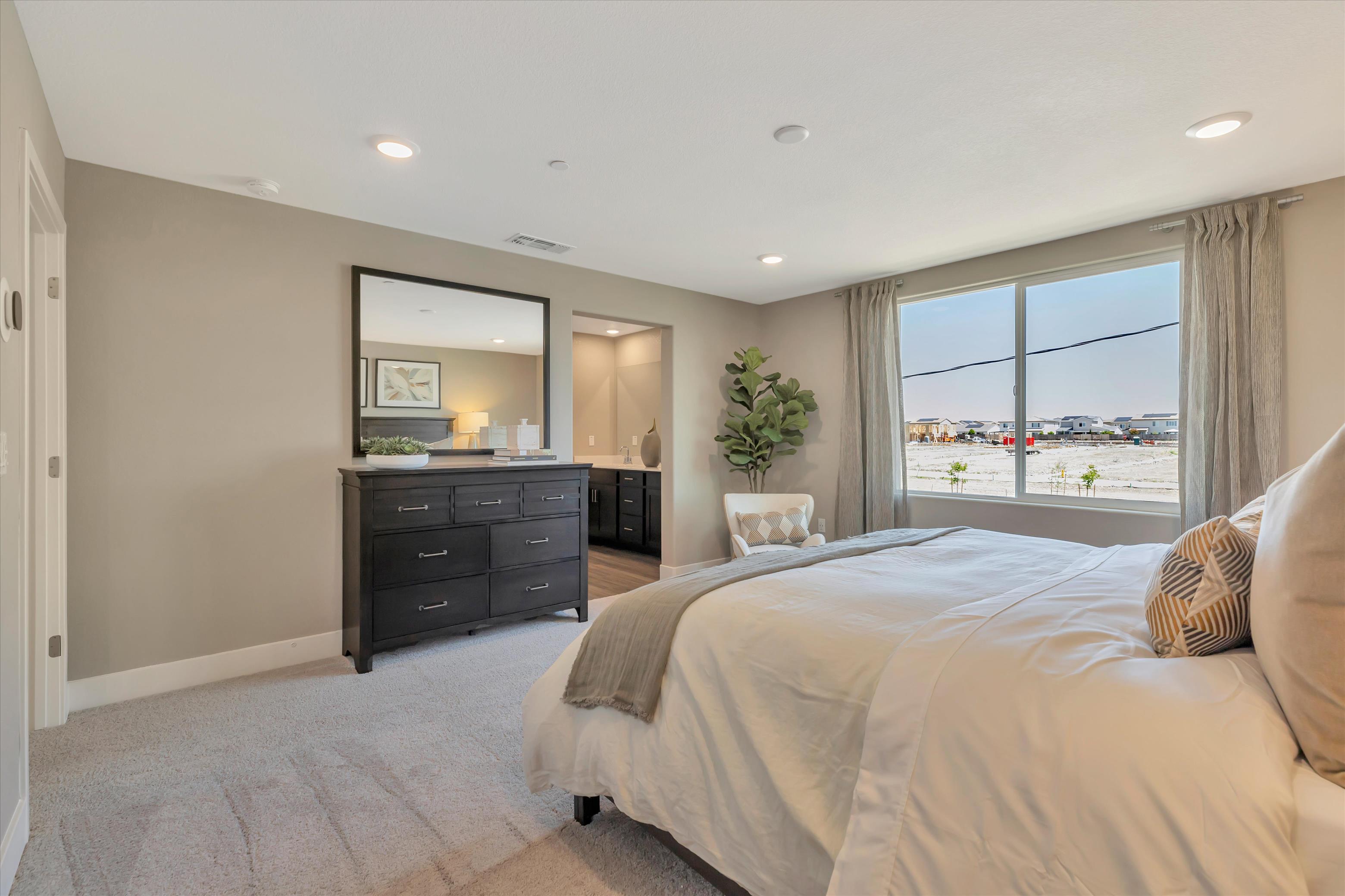 A bedroom with a large window.