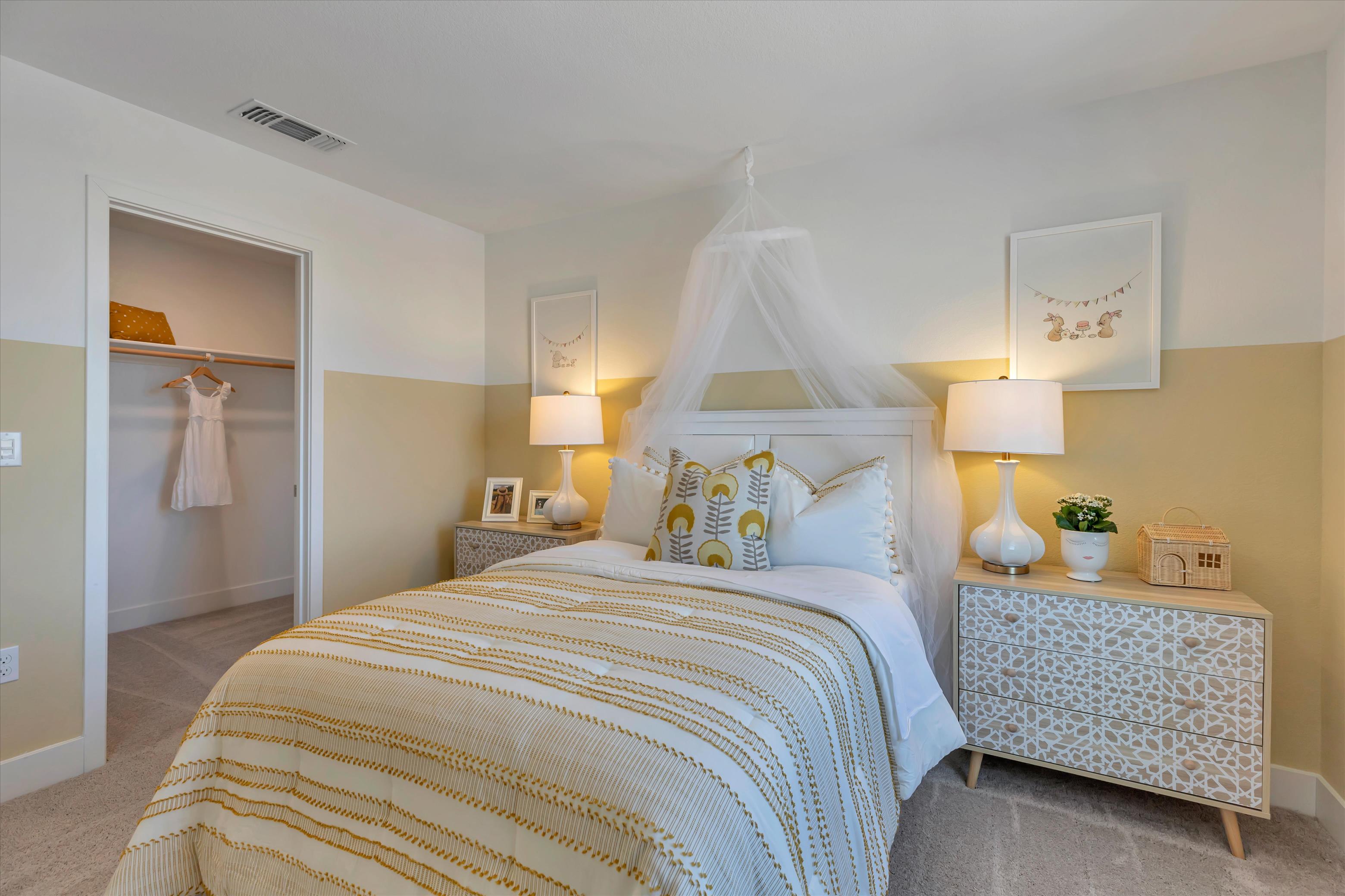 A bedroom with a bed and lamps.