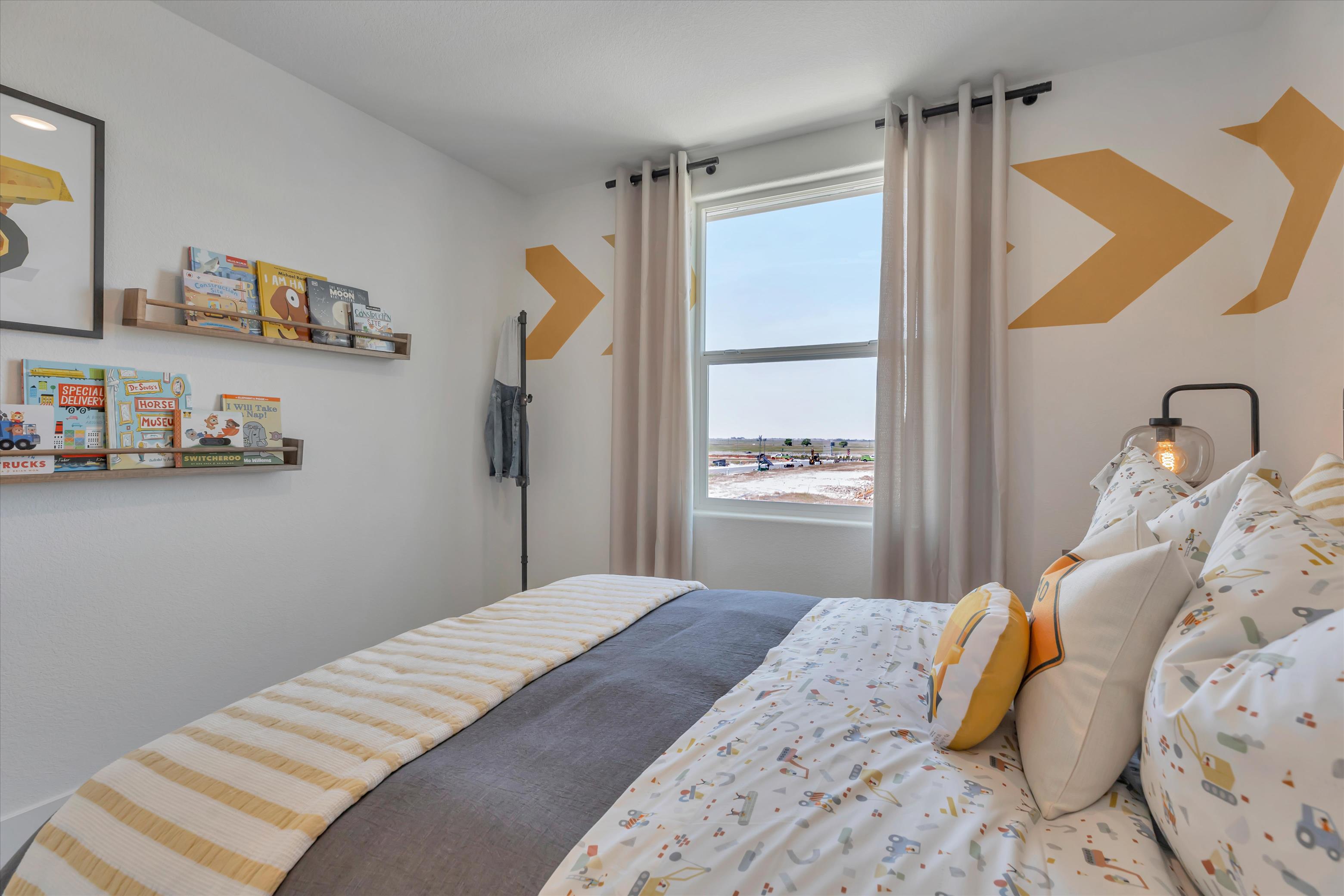 A bedroom with a bed and a window.