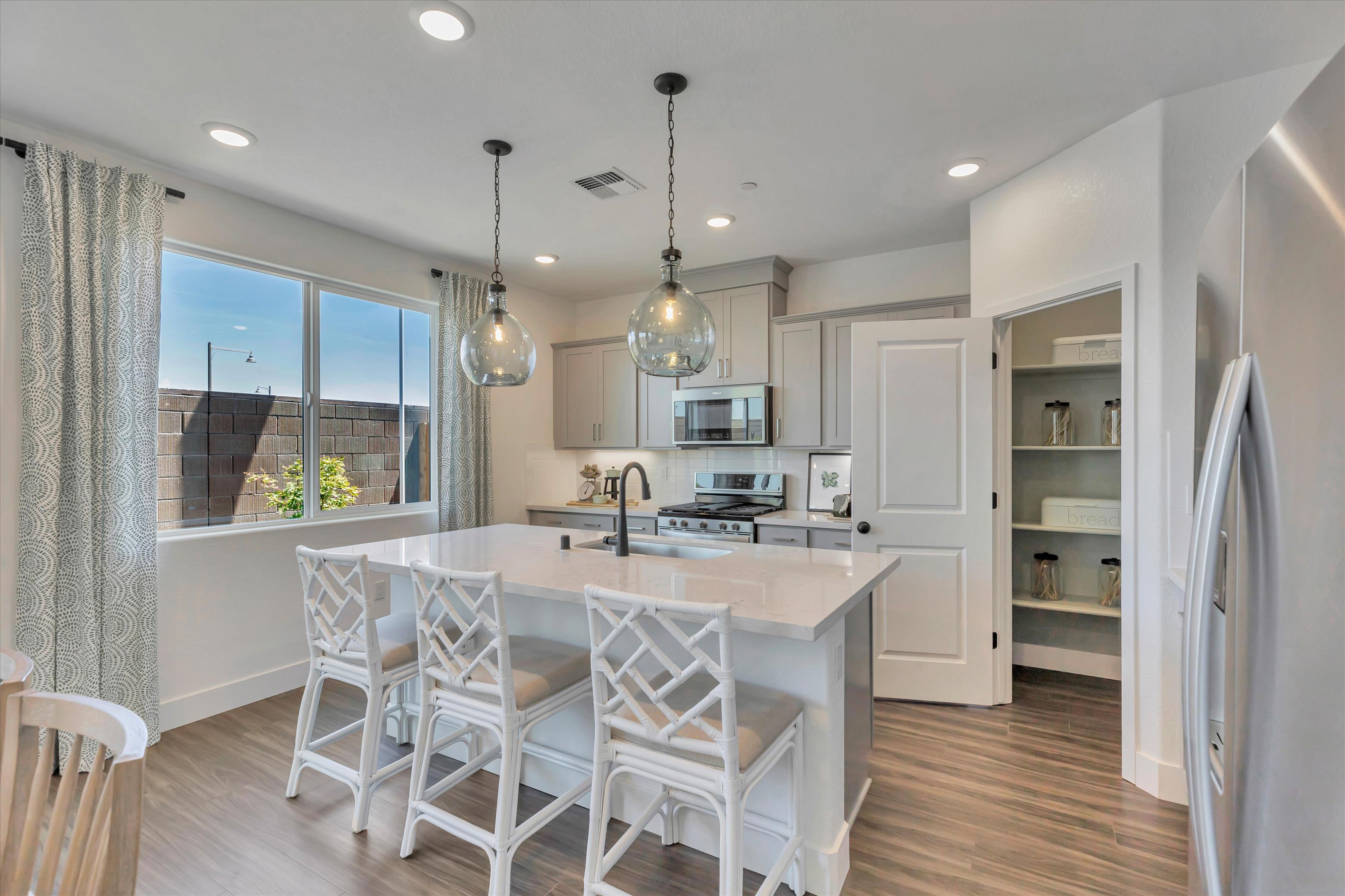 A kitchen with a dining table and a large window.