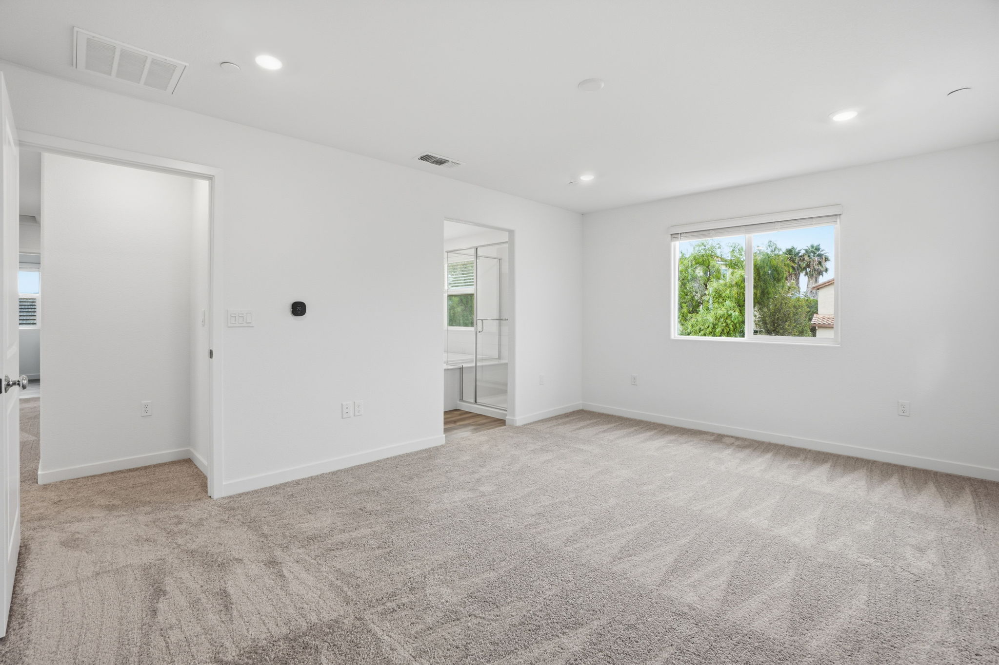A room with white walls and a window.