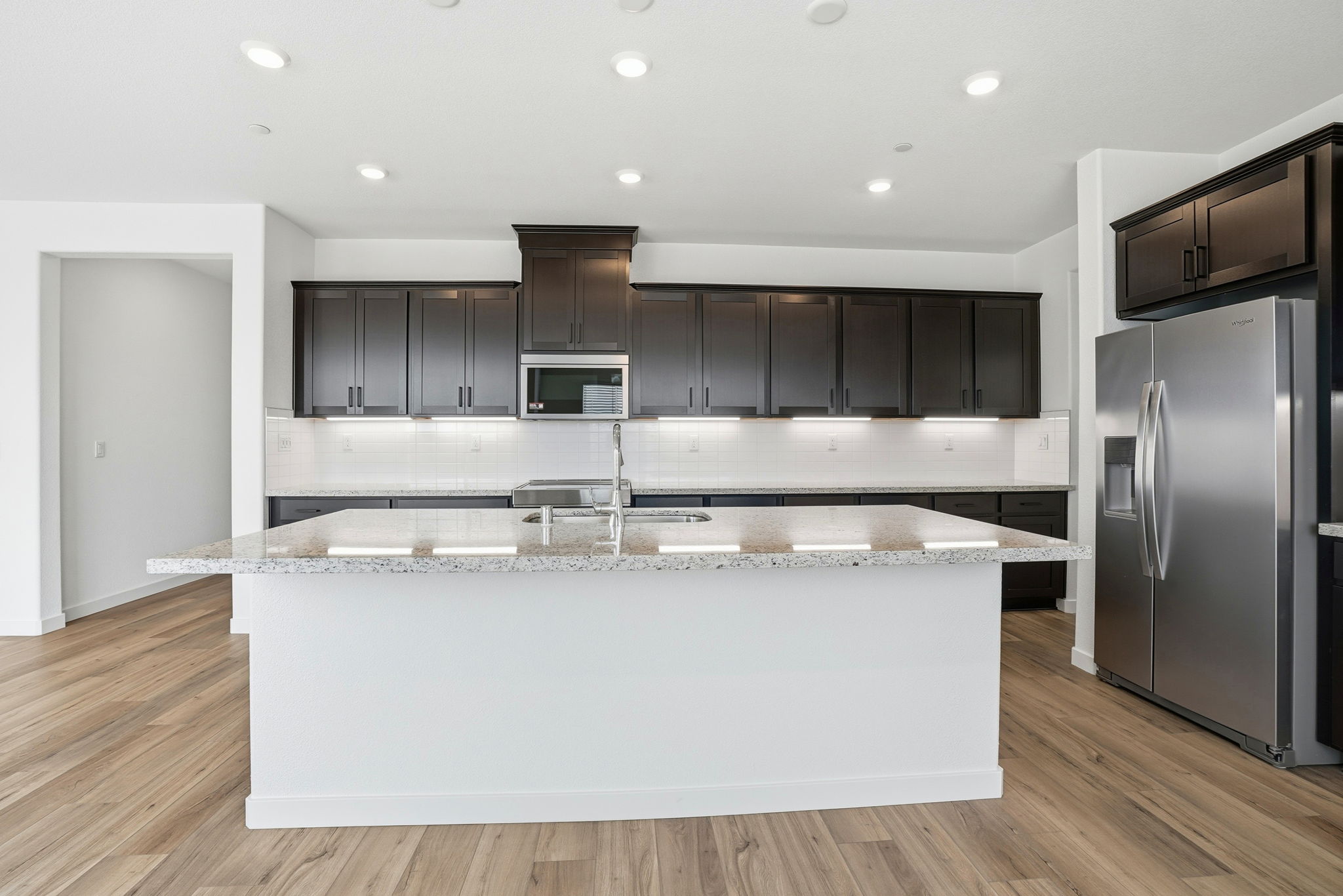 A kitchen with black cabinets.