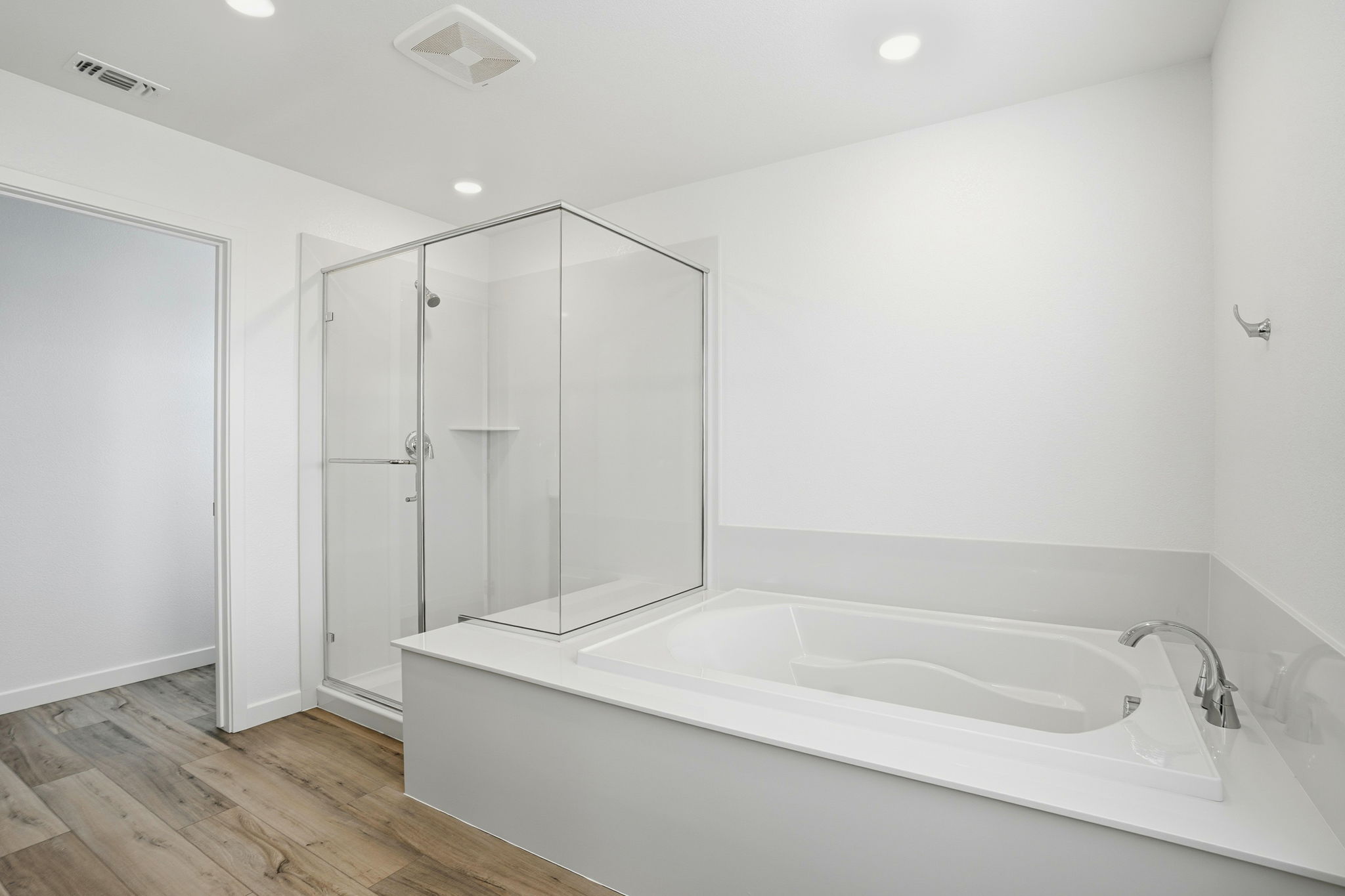 A bathroom with a tub and shower.