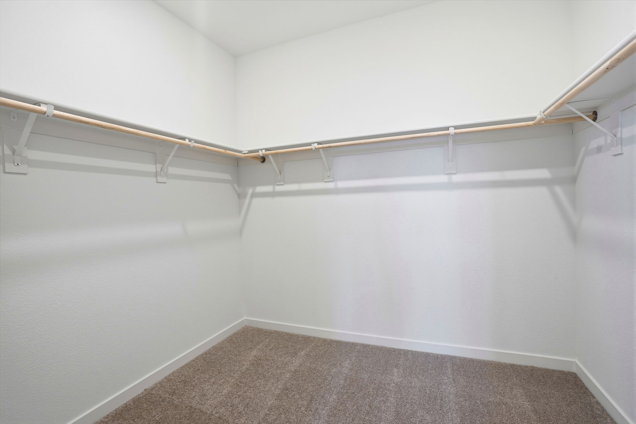 A white wall with a metal railing.
