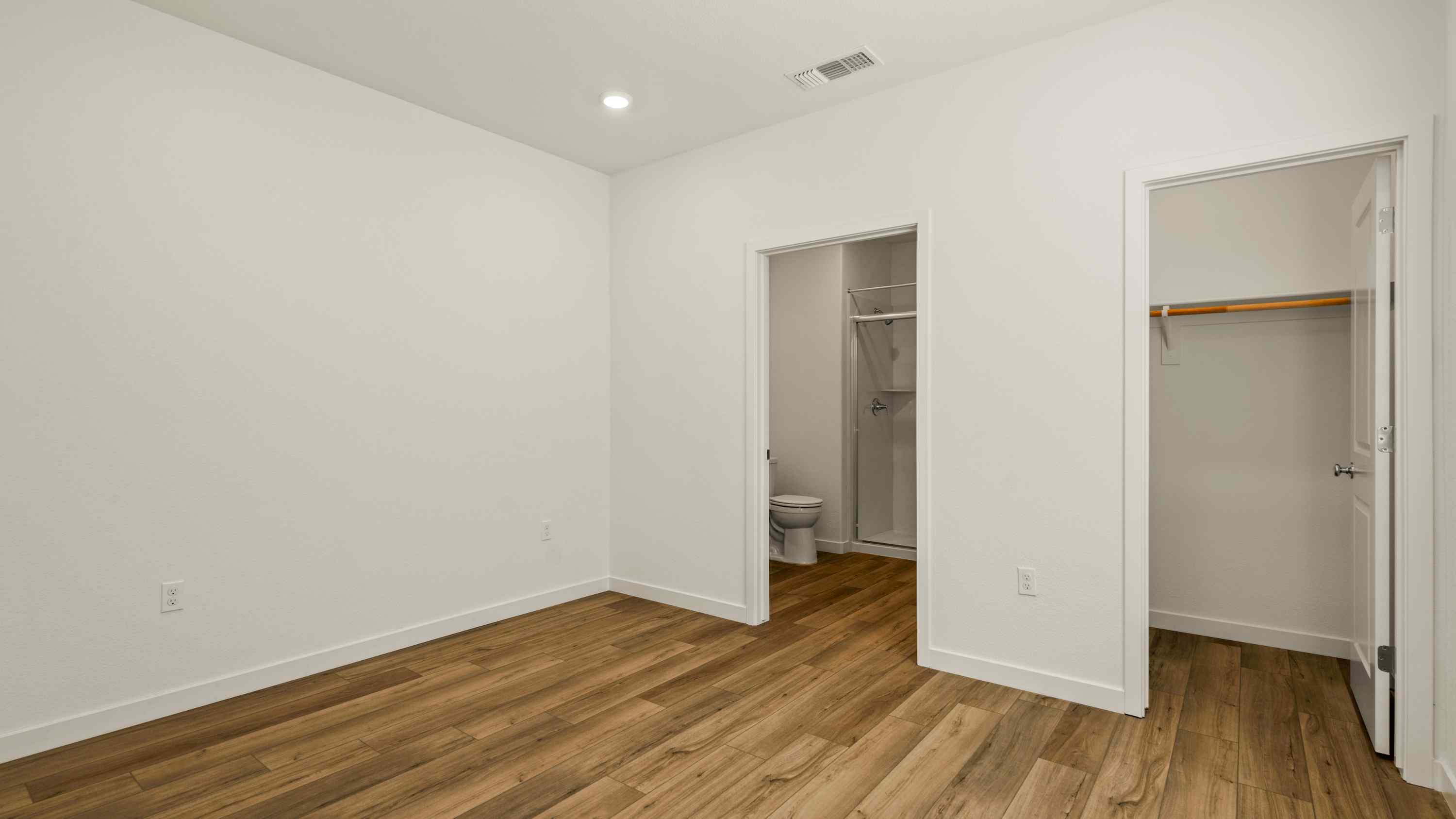 A room with a toilet and a shower.