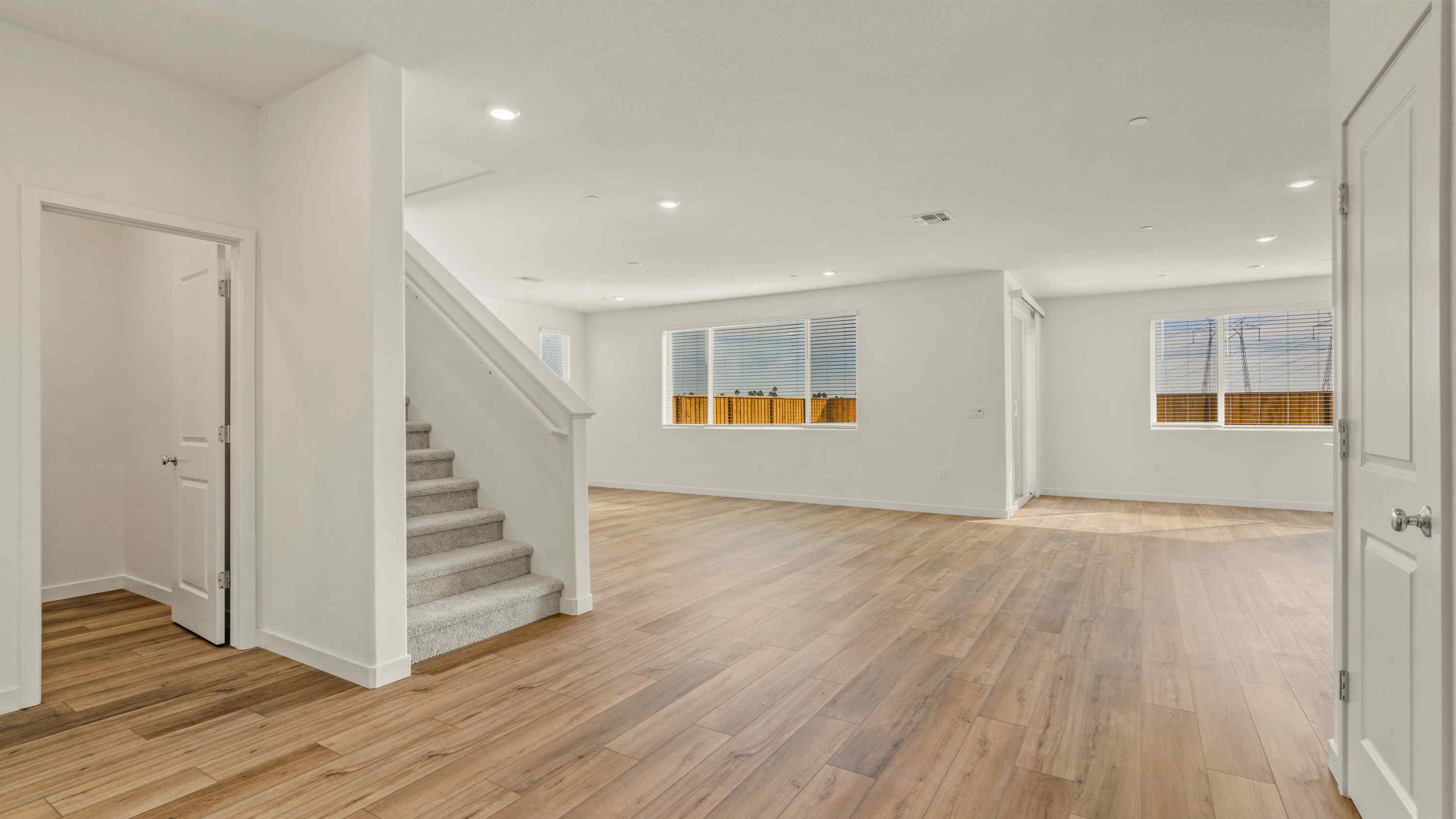 A room with white walls and wood floors.