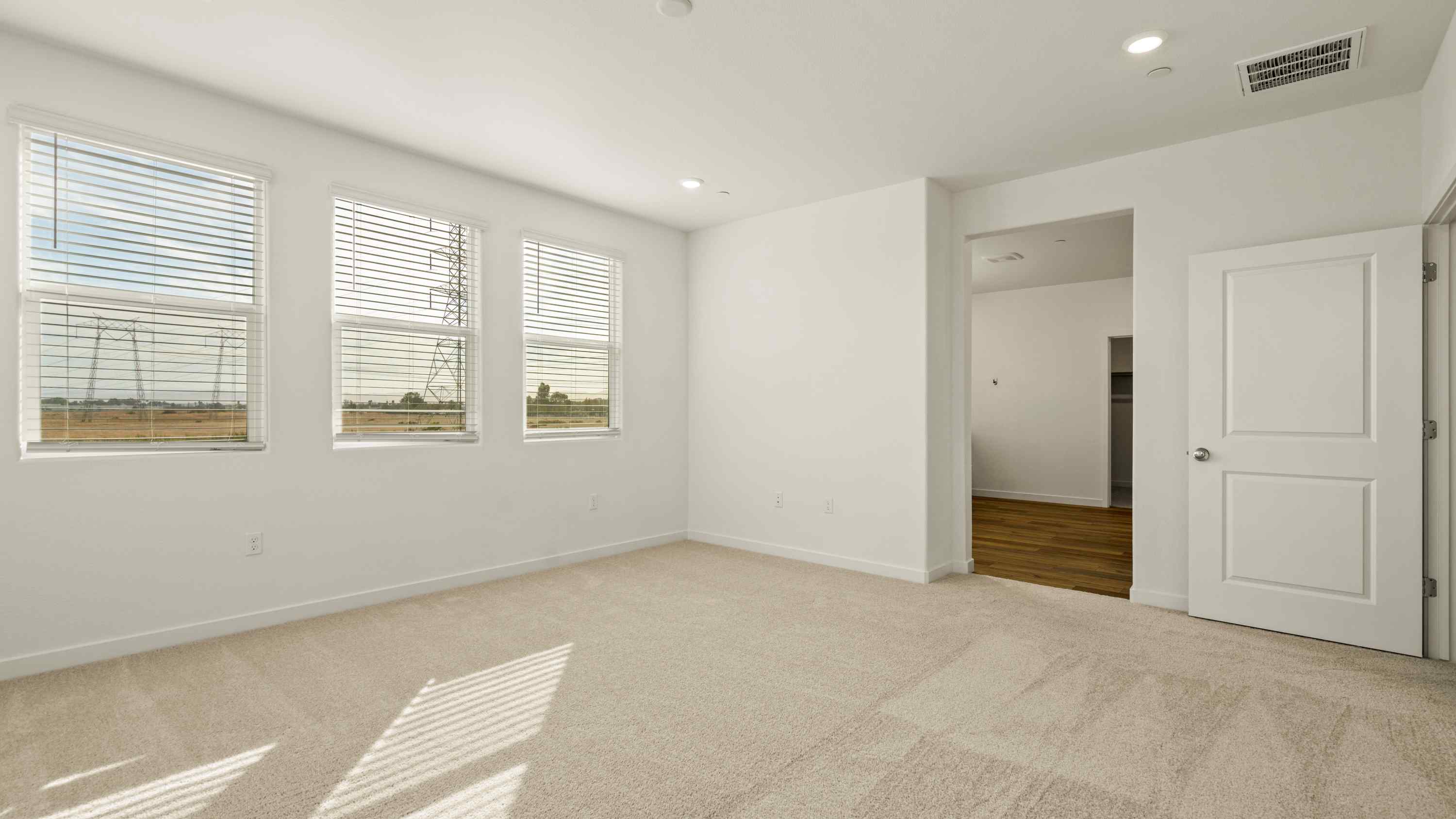 A room with white walls and a carpeted floor.