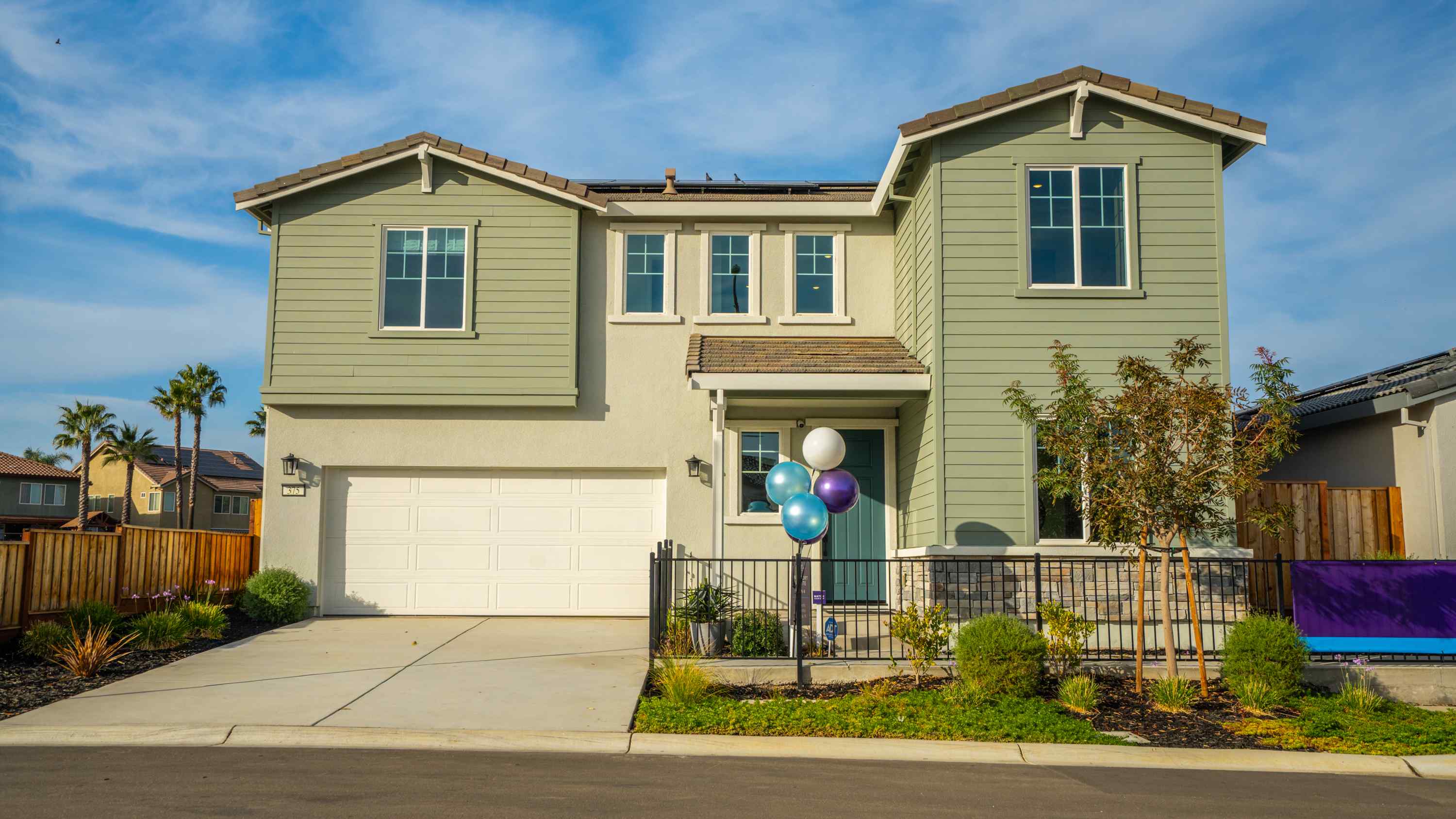 A house with balloons in front.