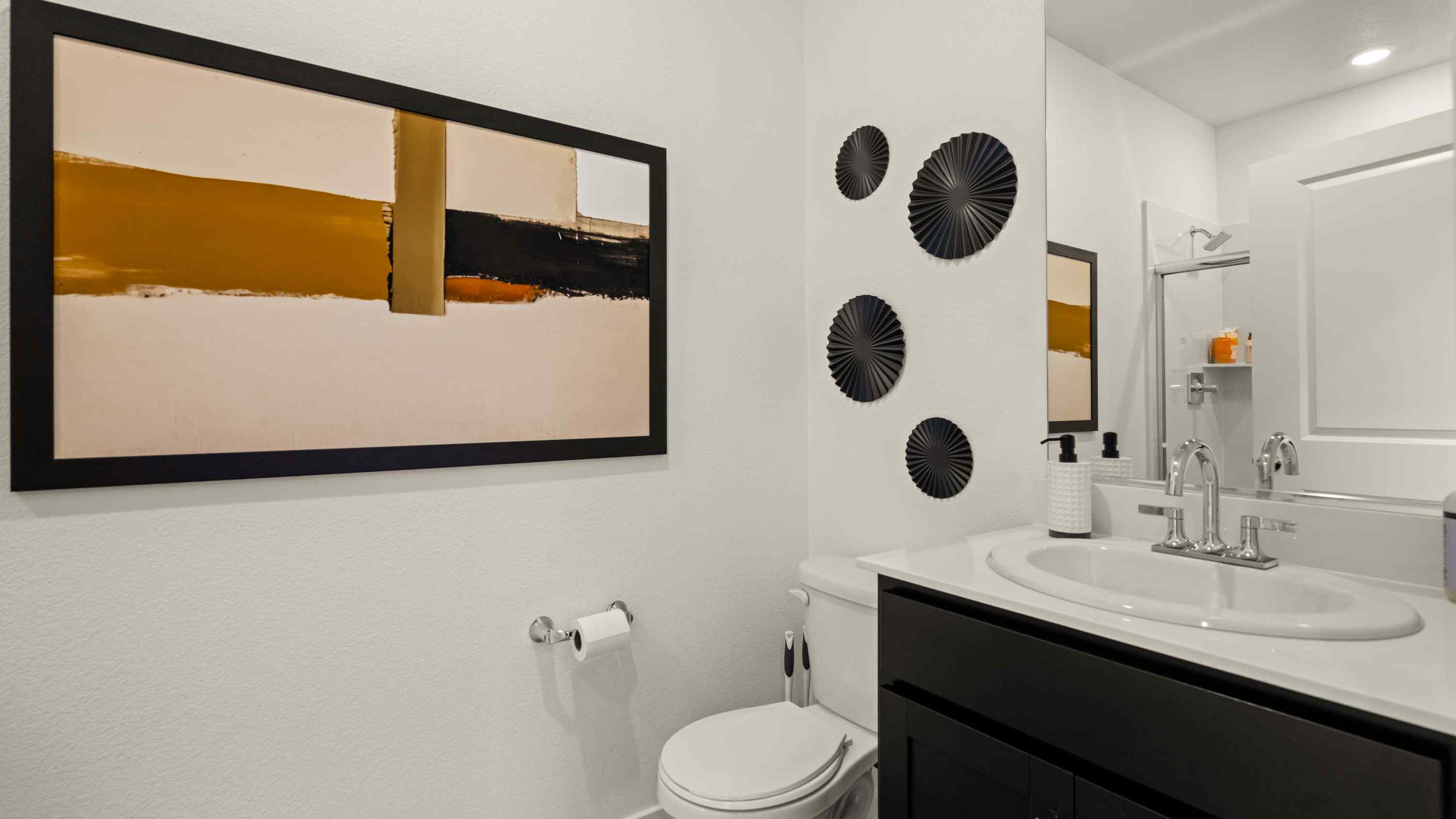 A bathroom with a large mirror.