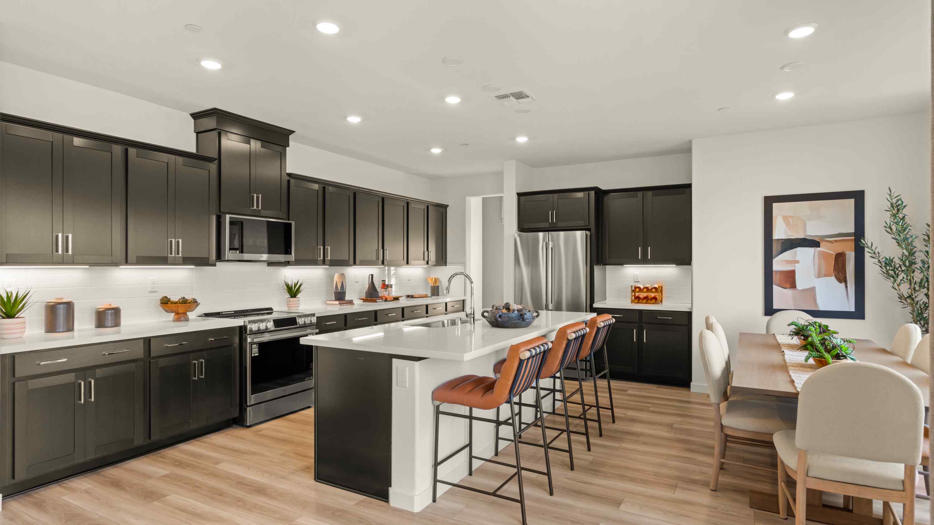 A kitchen with black cabinets.