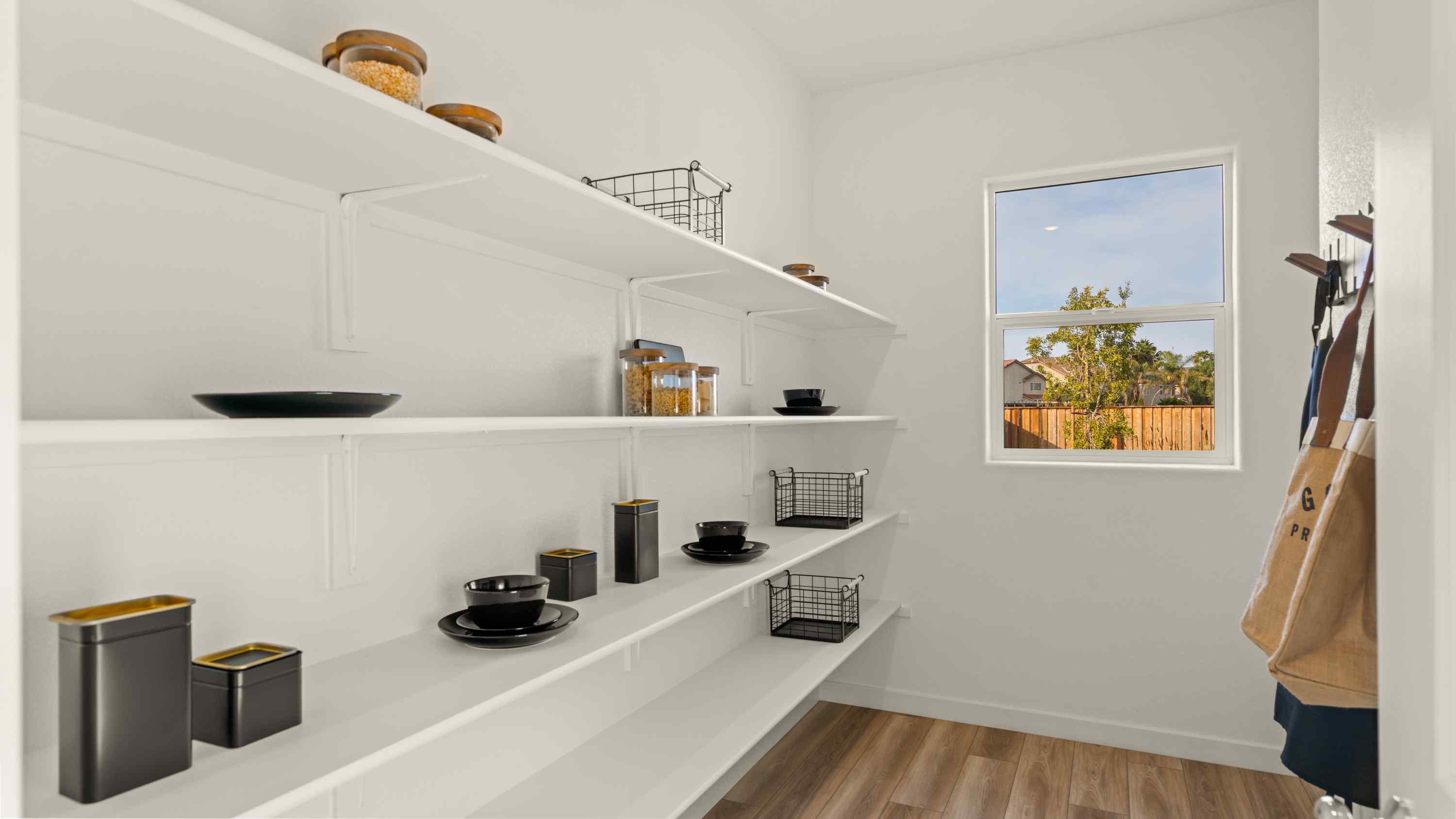 A white kitchen with a white shelf.