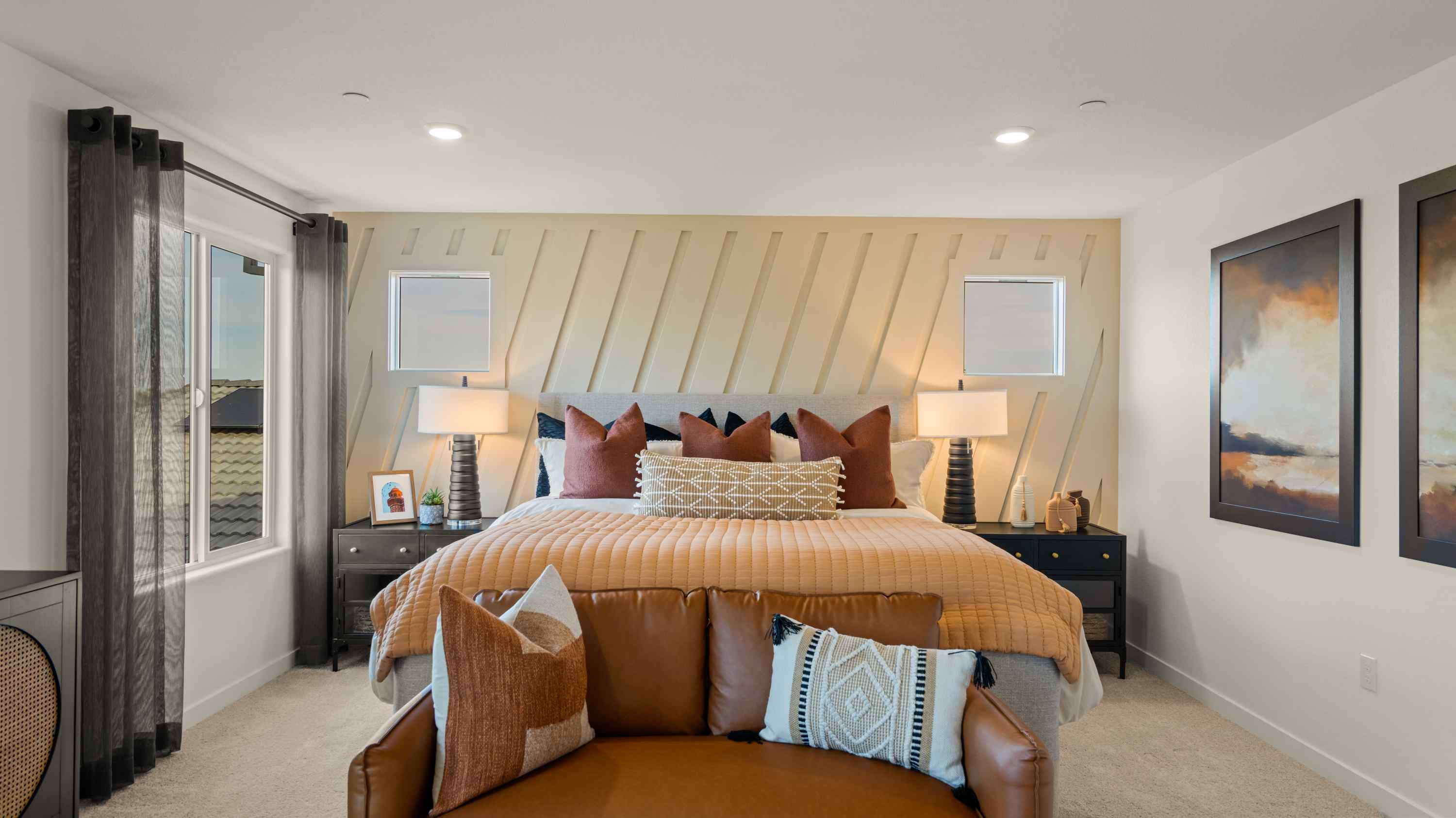A bedroom with a bed and lamps.