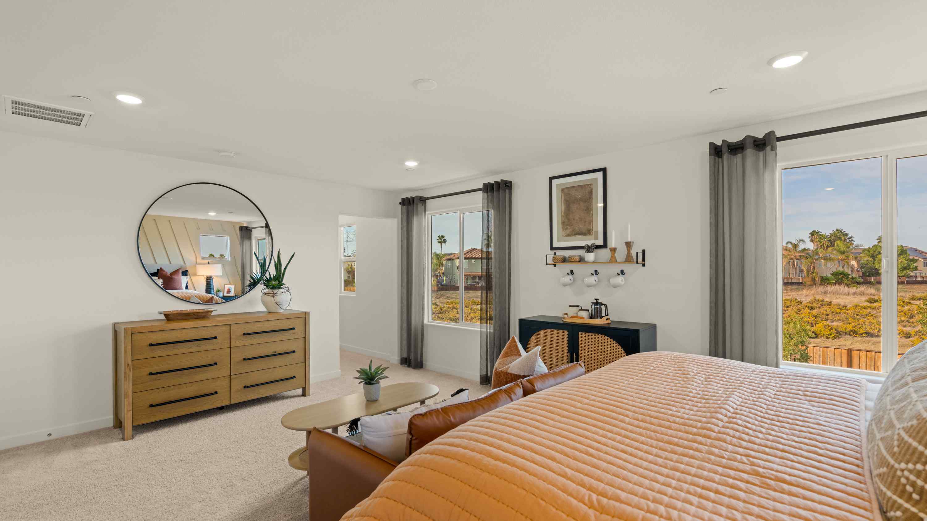 A bedroom with a large window.