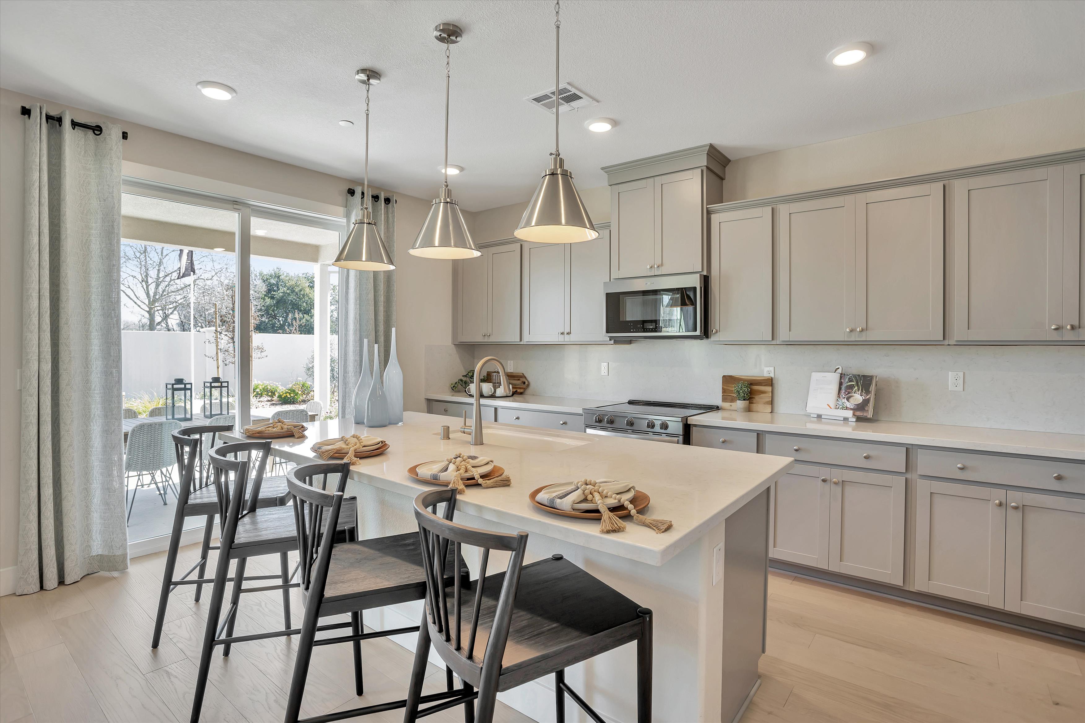 A kitchen with a table and chairs.