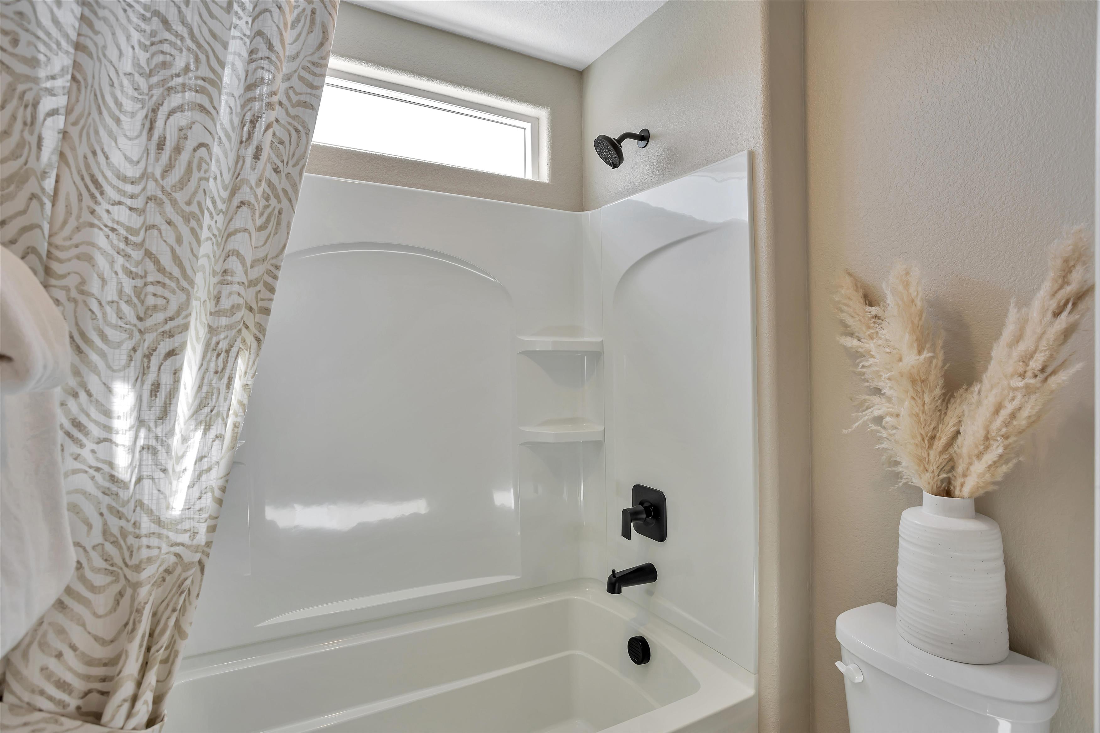 A bathroom with a shower curtain.