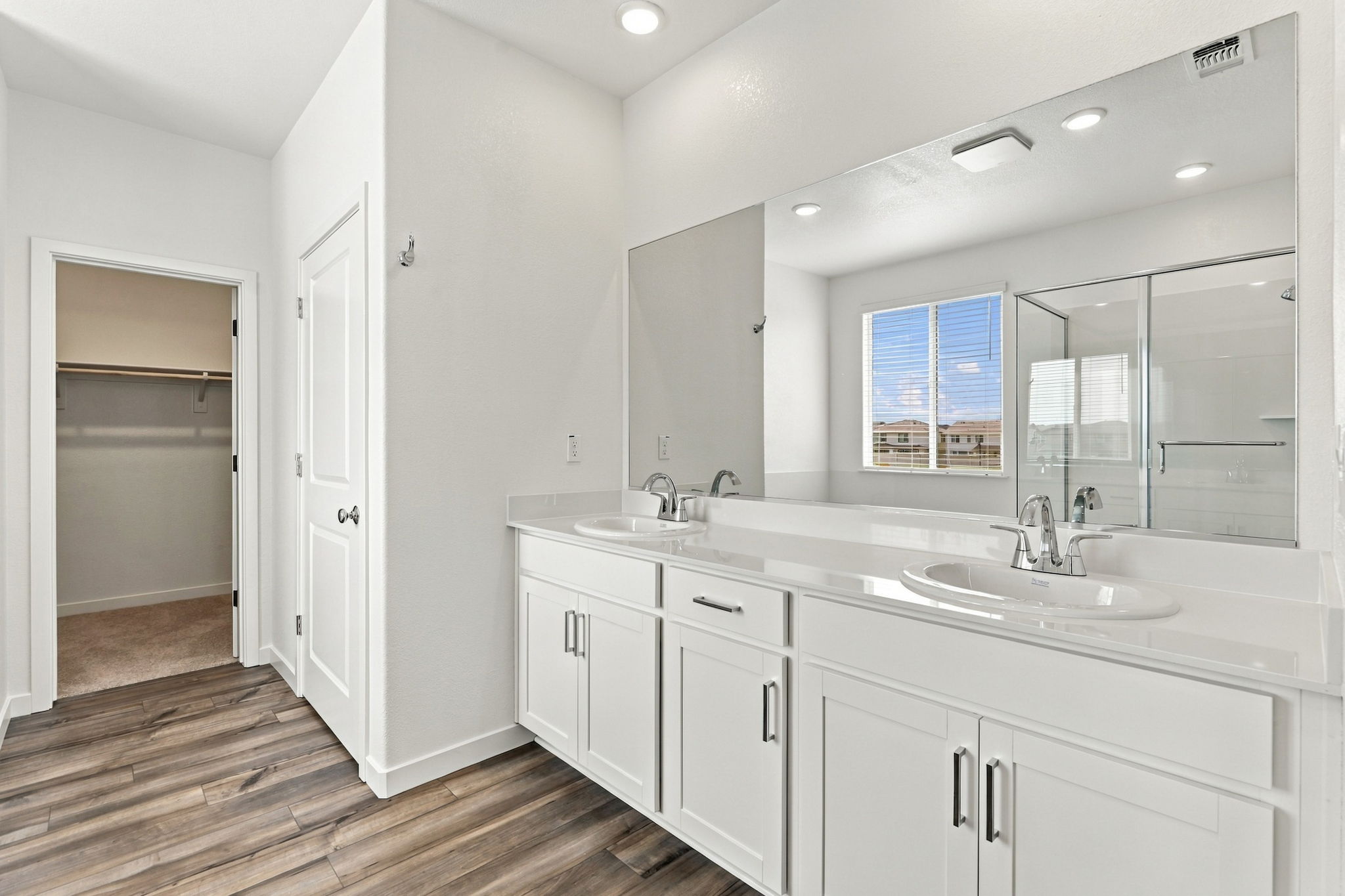 A bathroom with white cabinets.