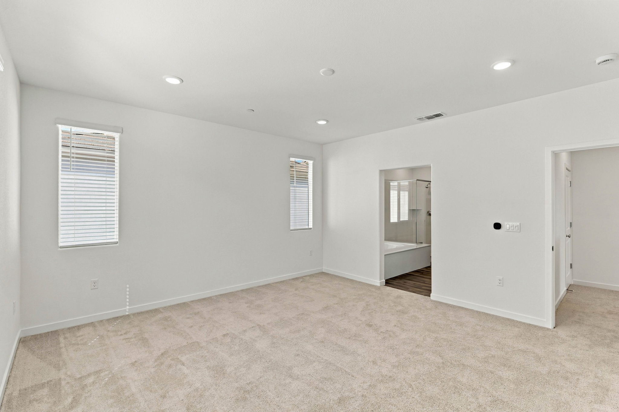 A room with a carpet and a door.