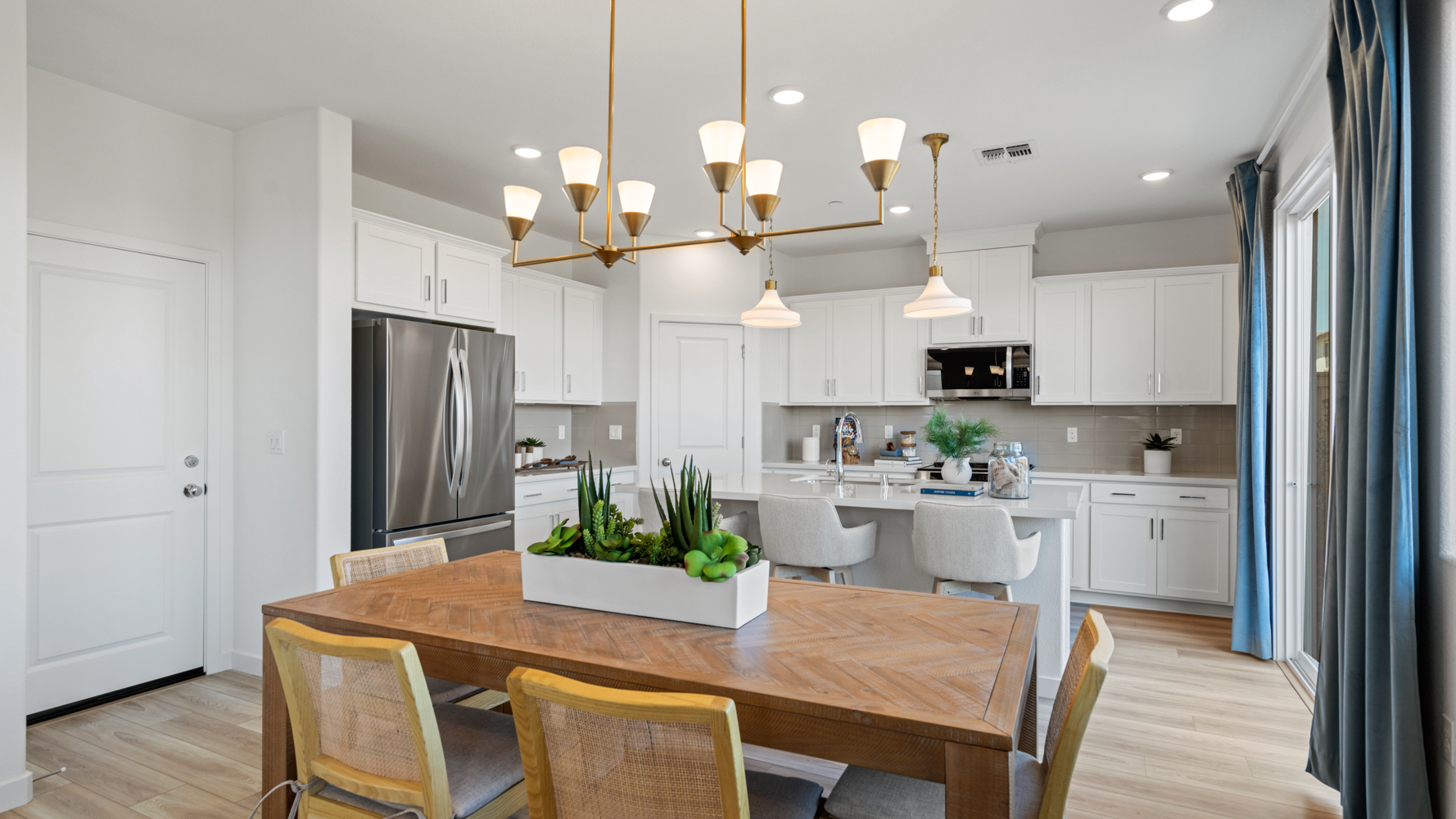 A kitchen with a table and chairs.