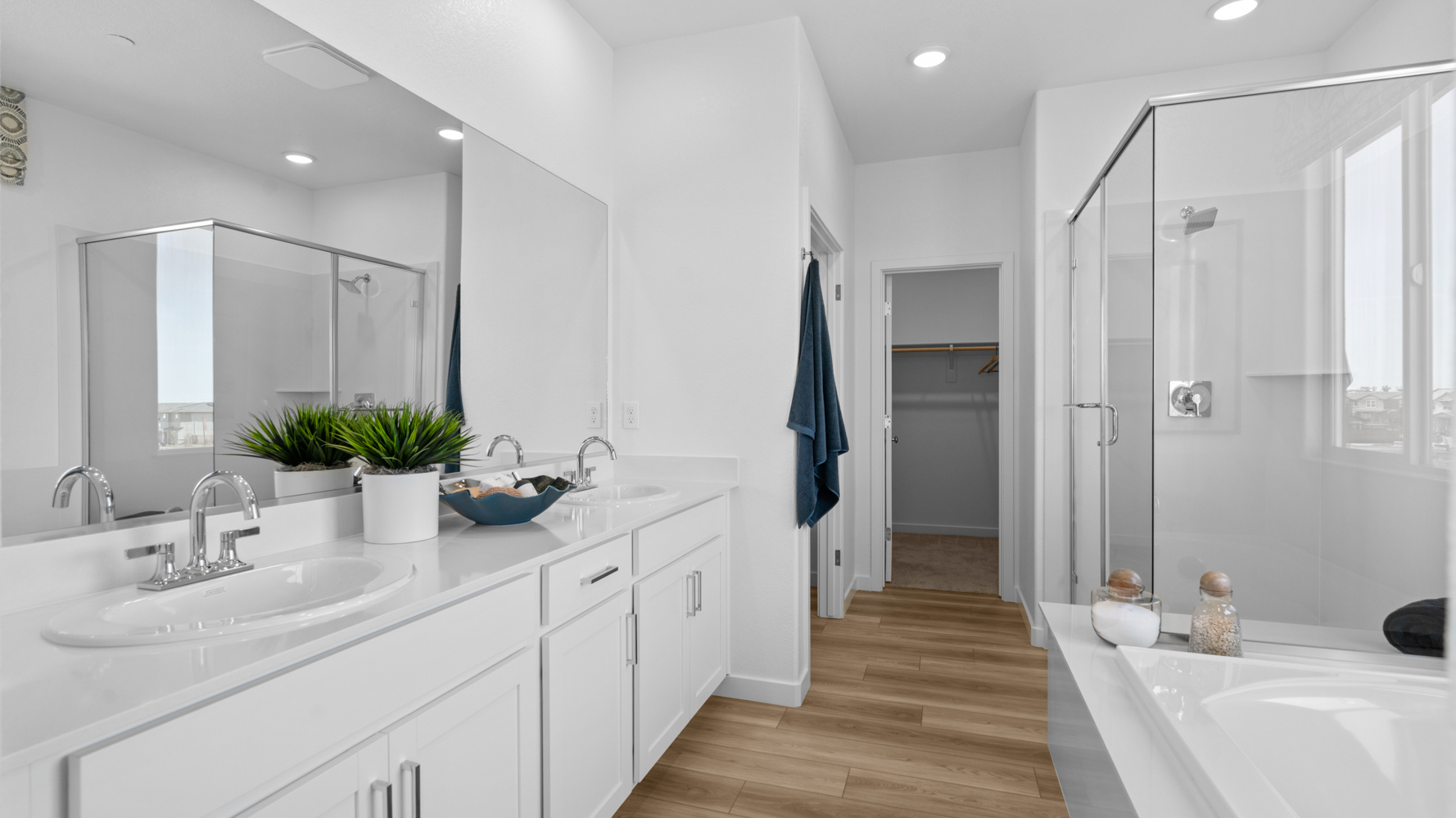 A bathroom with white cabinets.