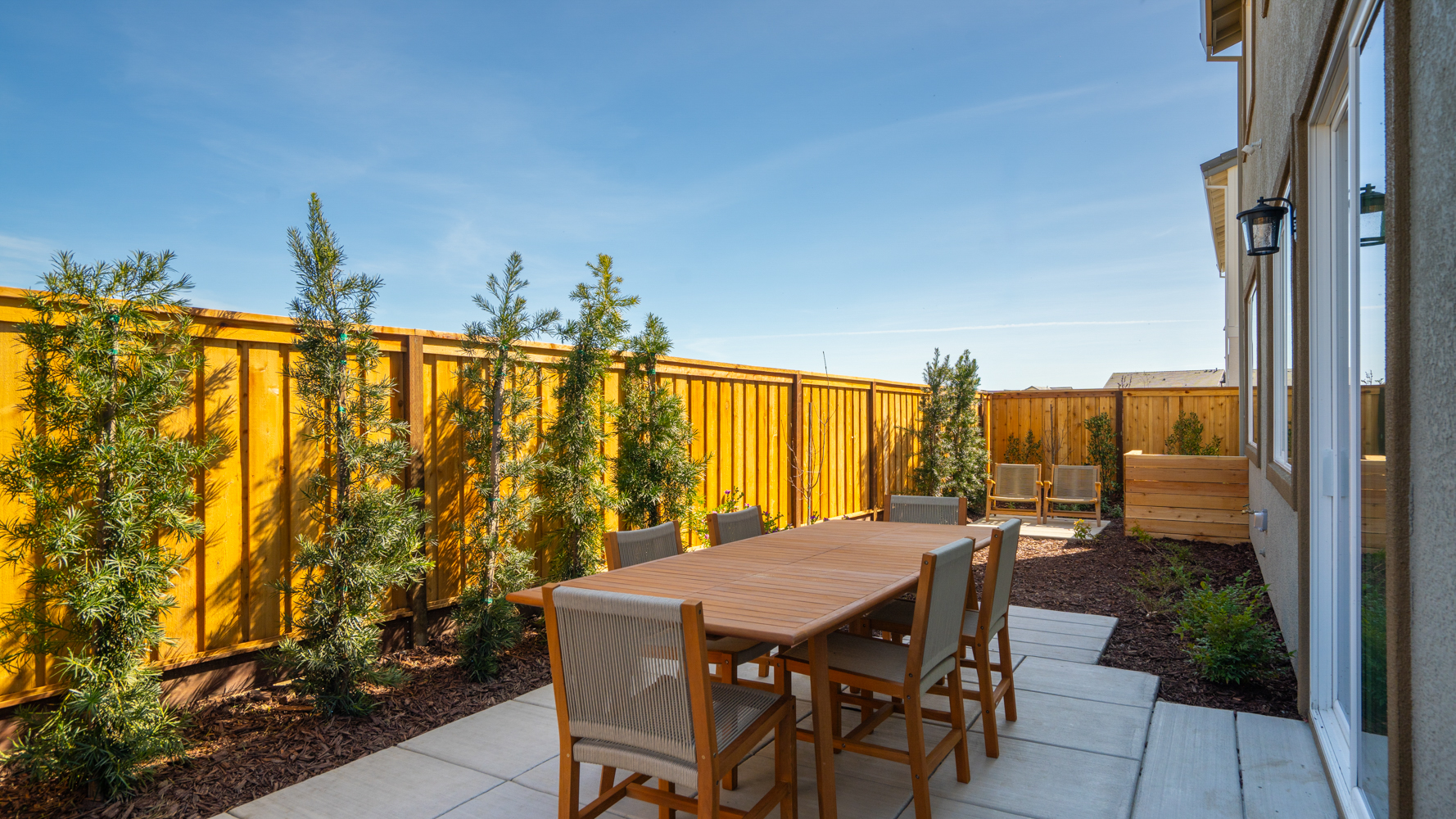 A table and chairs on a deck.