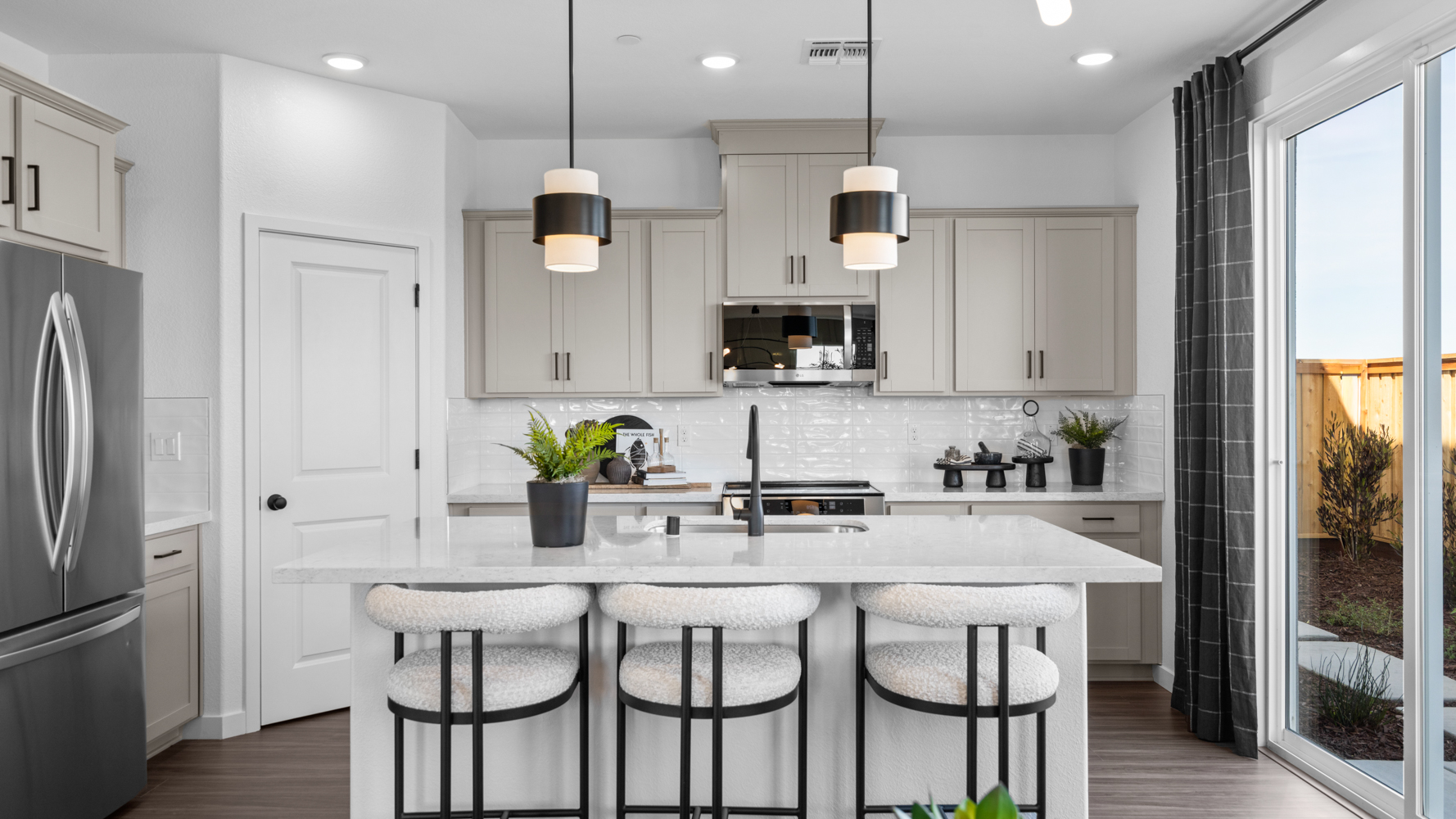A kitchen with white cabinets.