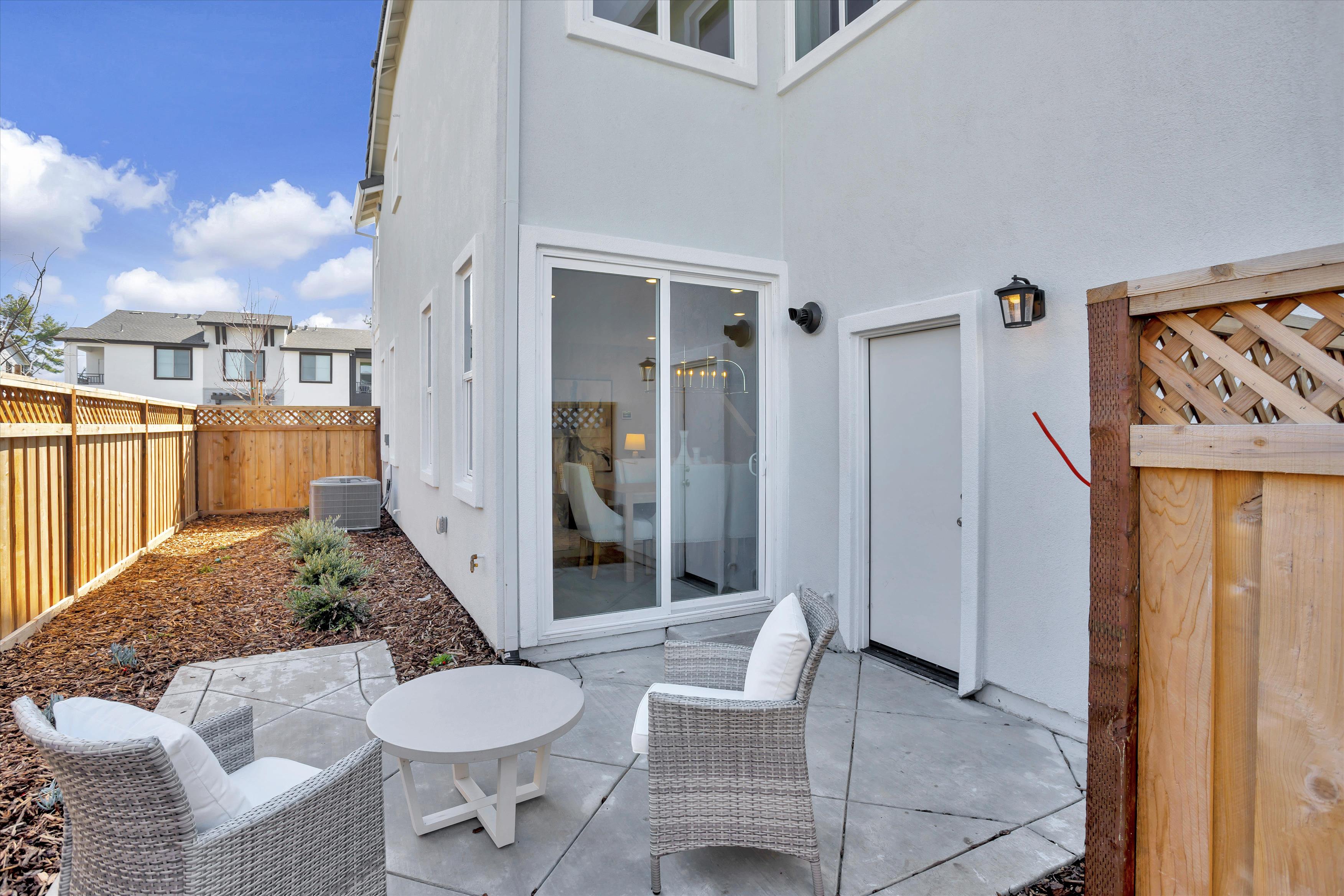 A patio with a table and chairs.