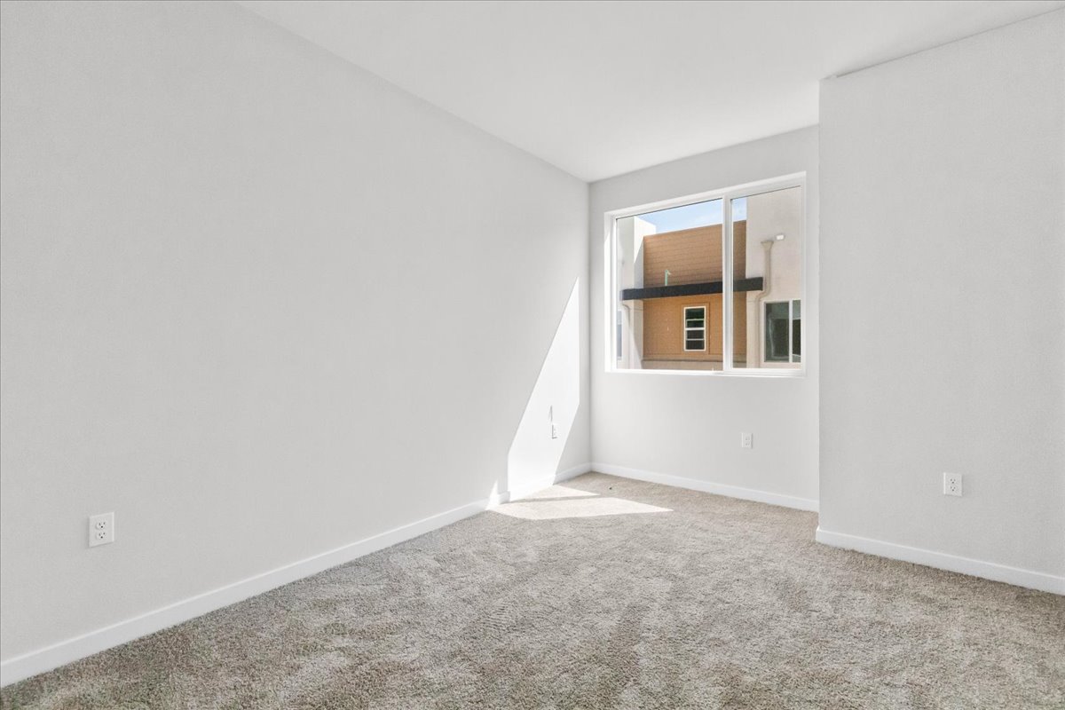 A room with a window and carpet.