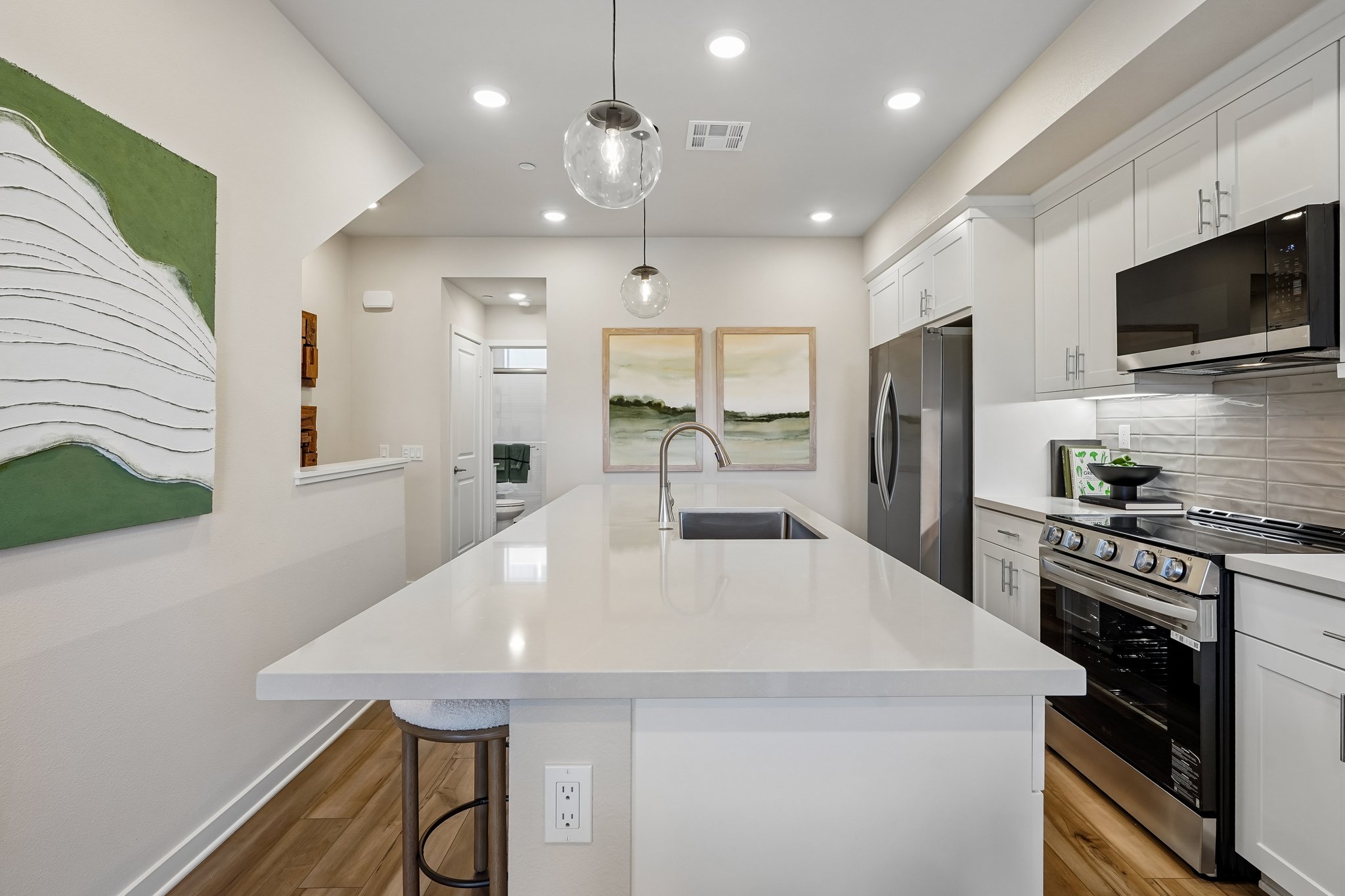 A kitchen with white cabinets.
