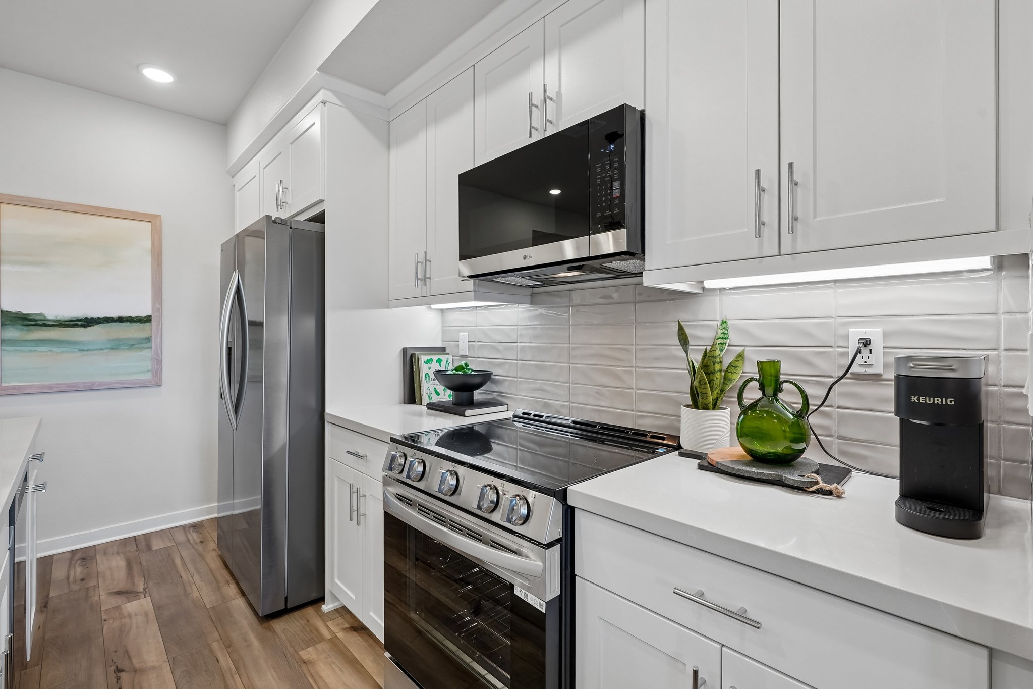A kitchen with white cabinets.