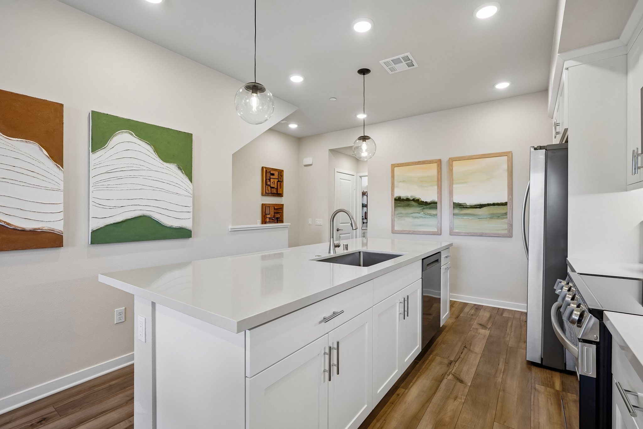 A kitchen with white cabinets.