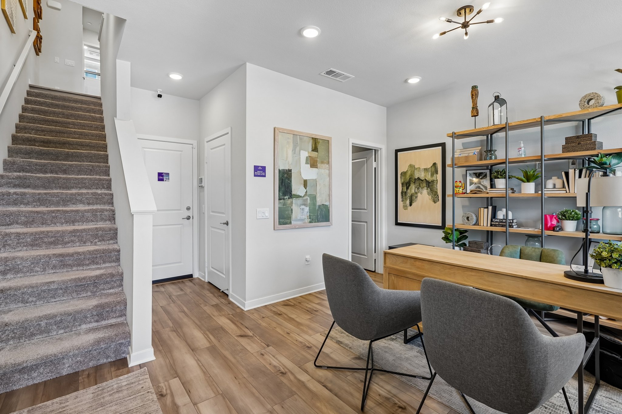 A room with a staircase and chairs.