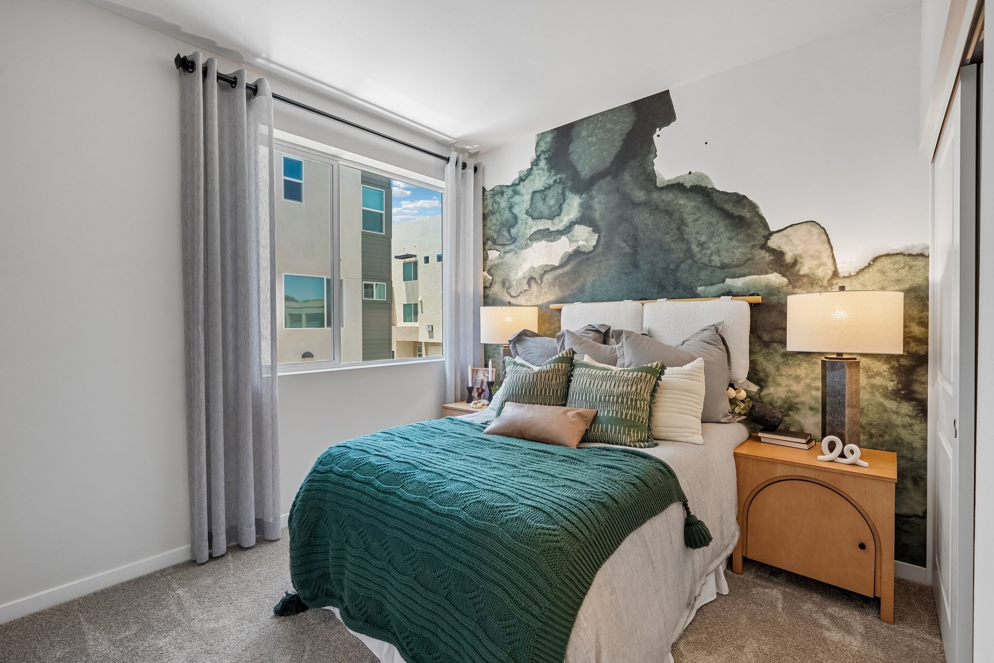 A bedroom with a large rock wall.